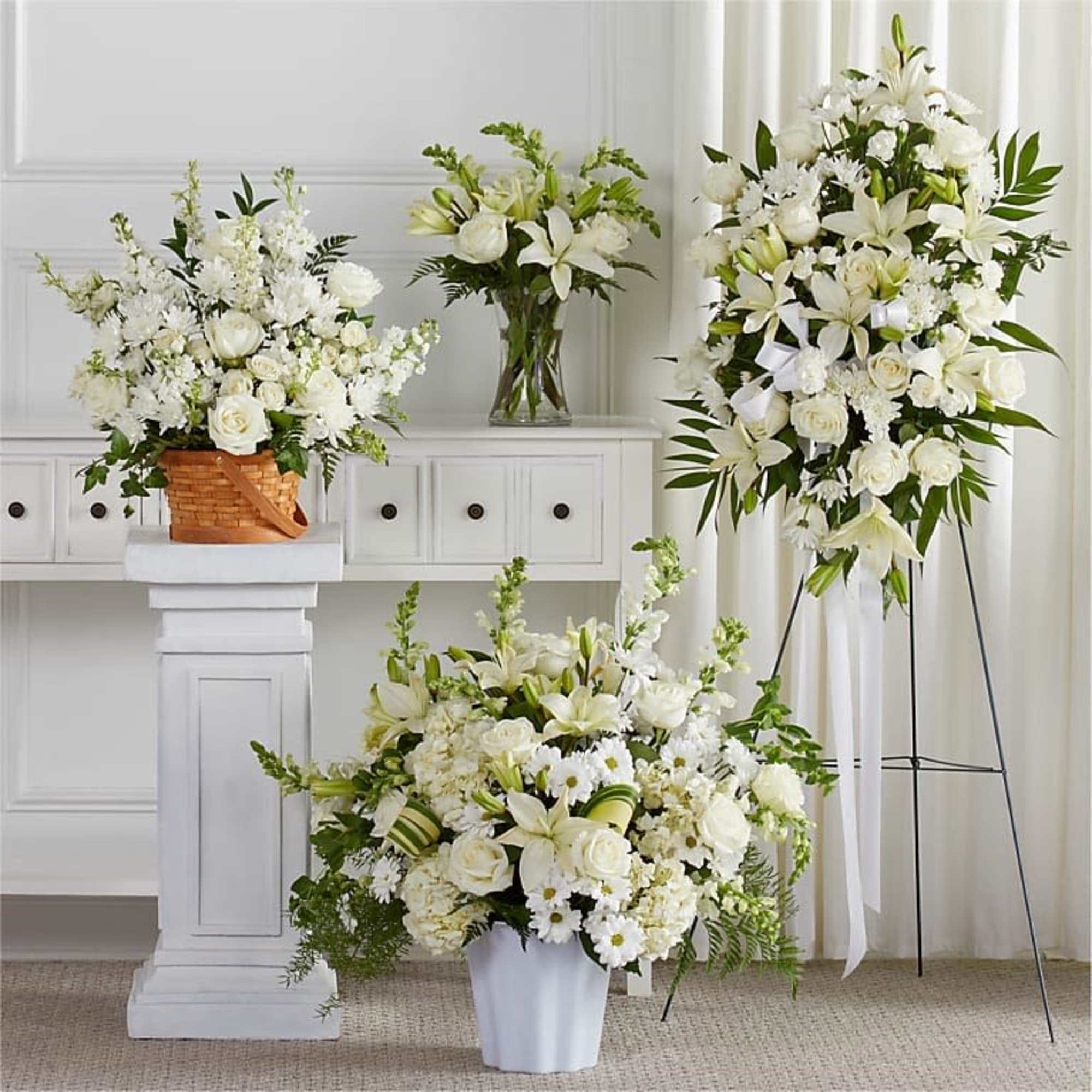All white arrangements set a calm, elegant tone-perfect as a sympathy arrangement.