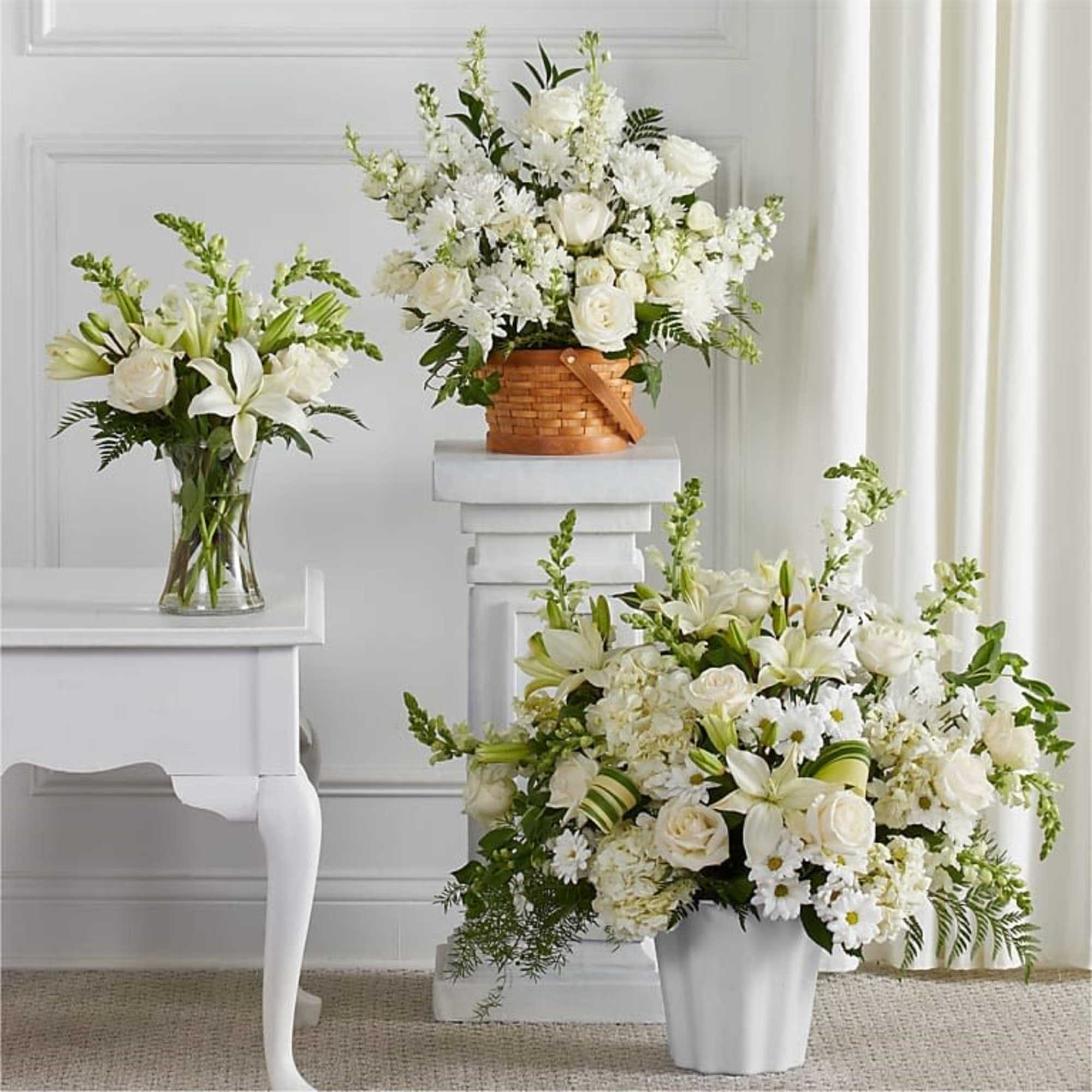 All white arrangements set a calm, elegant tone-perfect as a sympathy arrangement.