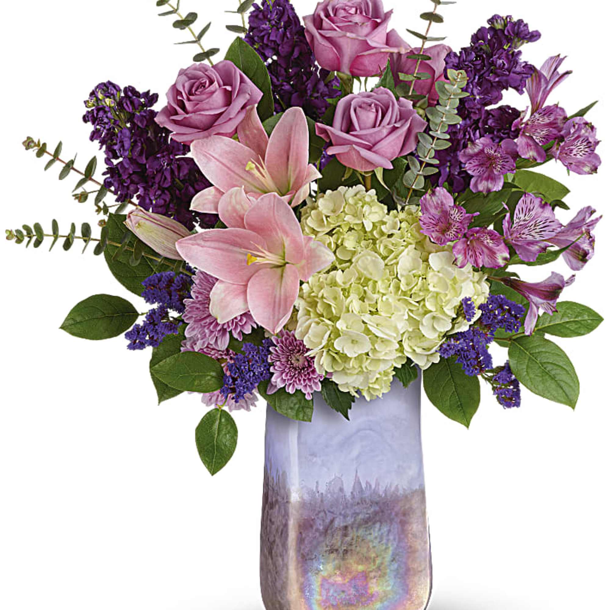 Pink roses, lilies, hydrangea, and purple flowers in a tall vase