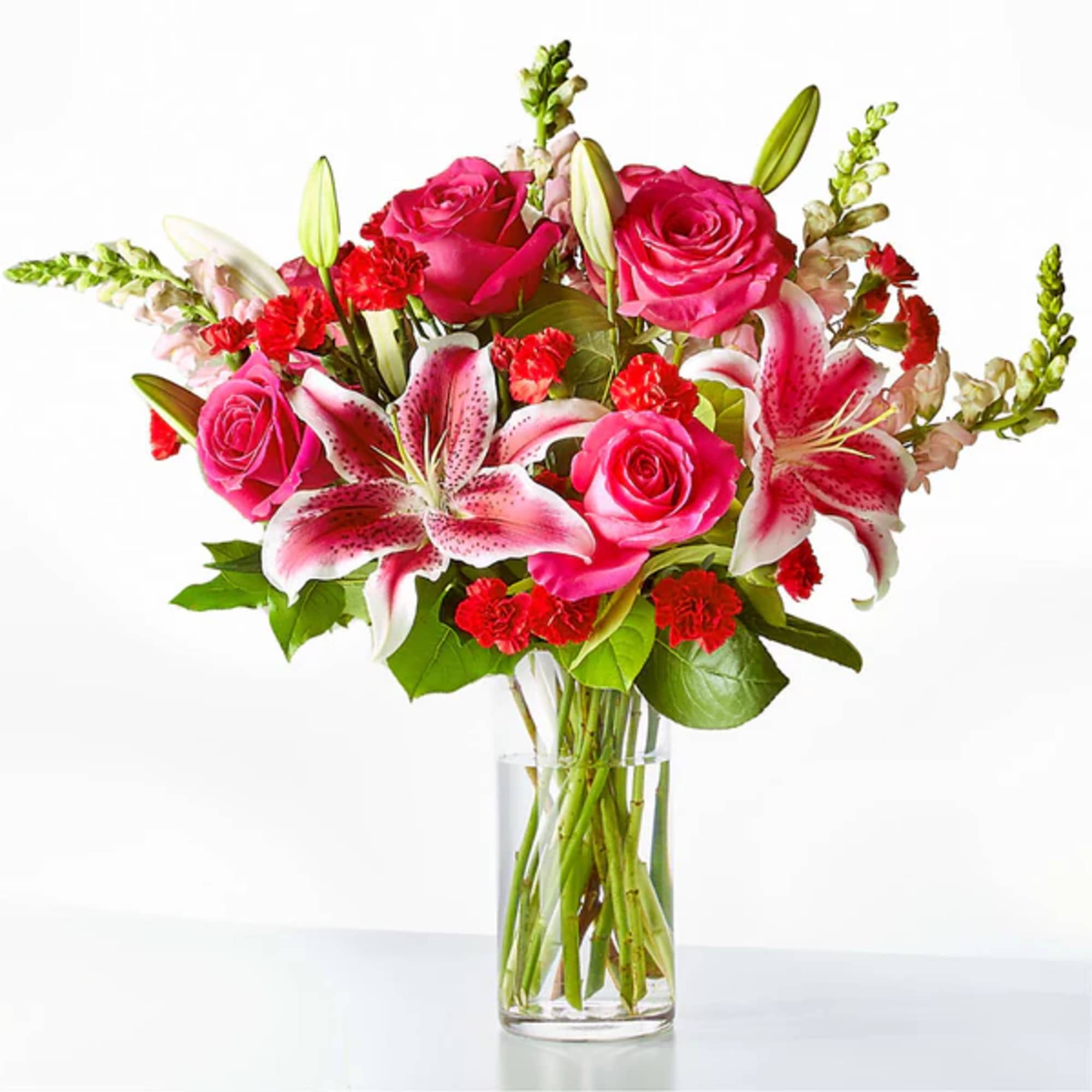 Pink roses and stargazer lilies in a clear glass vase