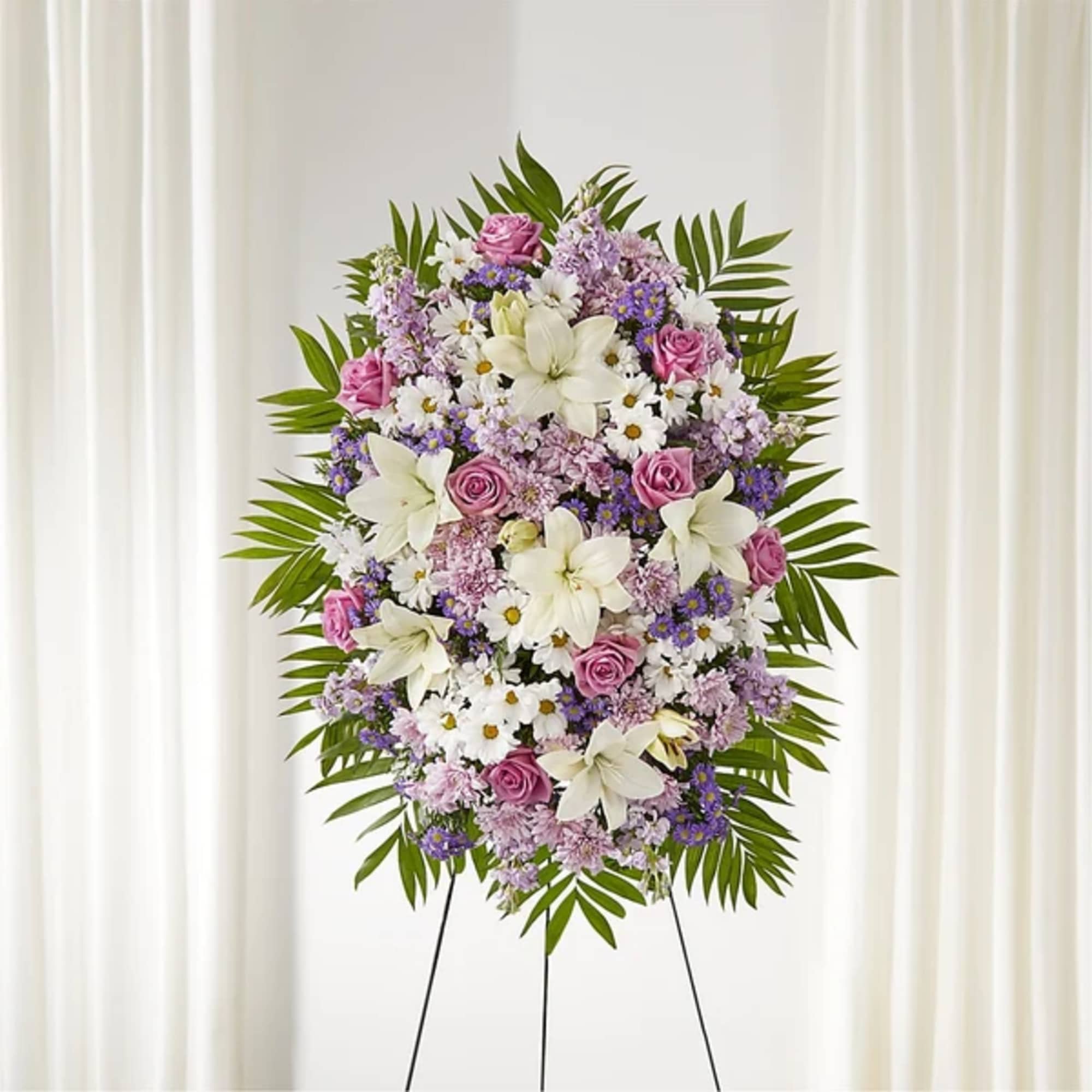 Standing floral spray with pink roses, white lilies, and purple flowers