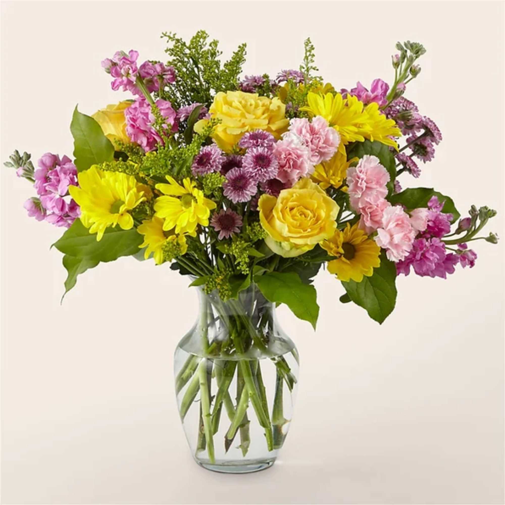Bouquet of yellow and pink flowers in a clear glass vase