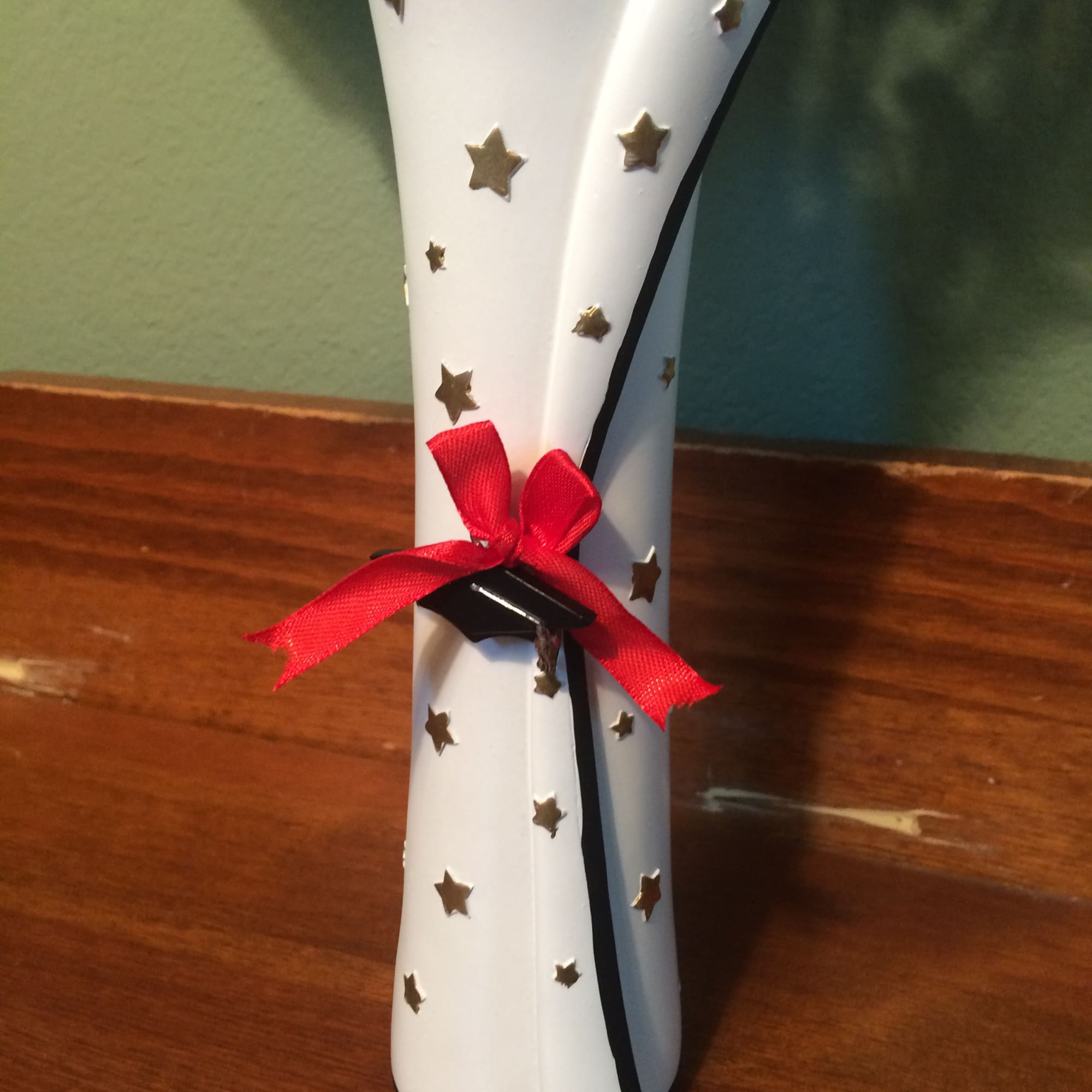 White star-patterned paper cone tied with a red ribbon
