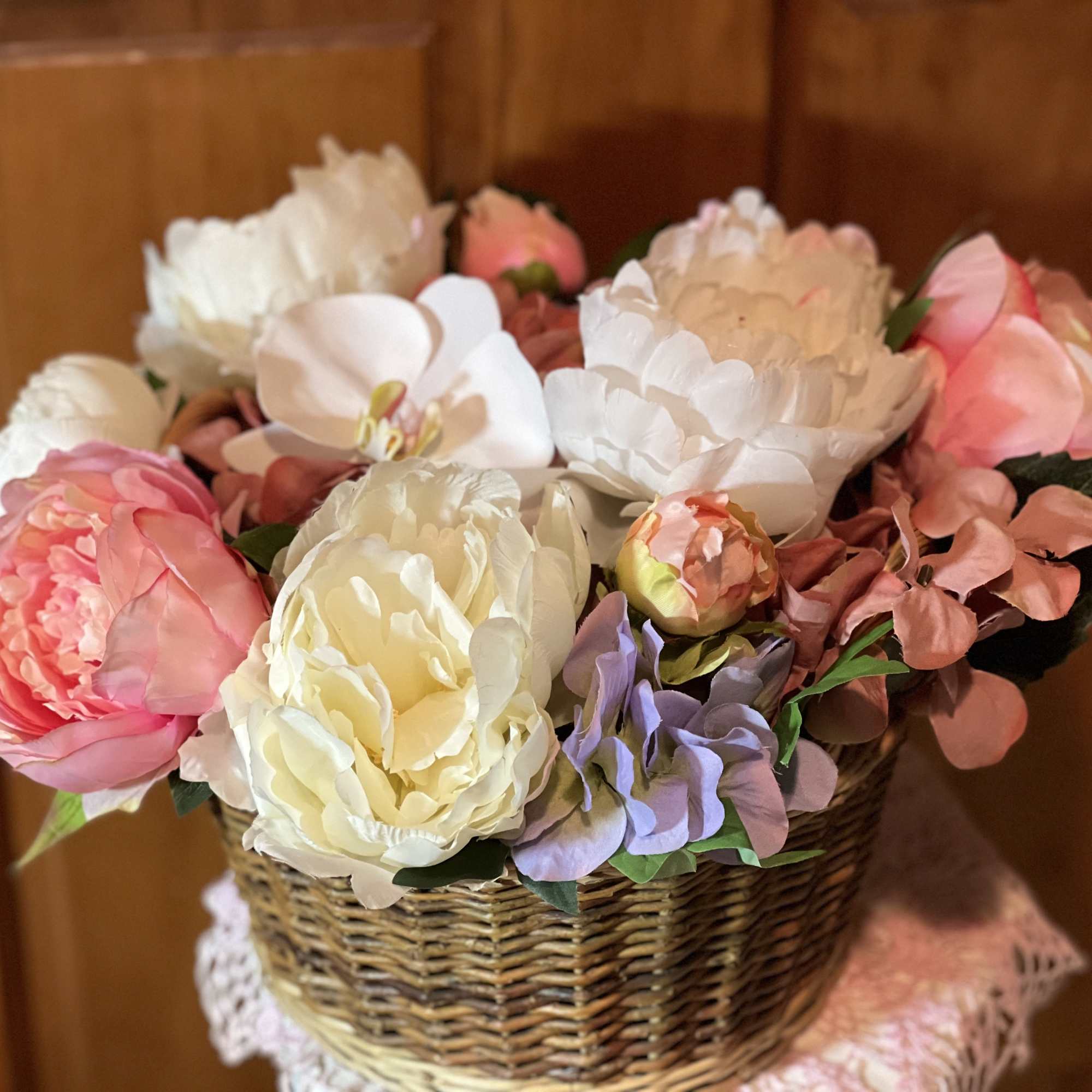 Basket of pastel artificial peonies and hydrangeas