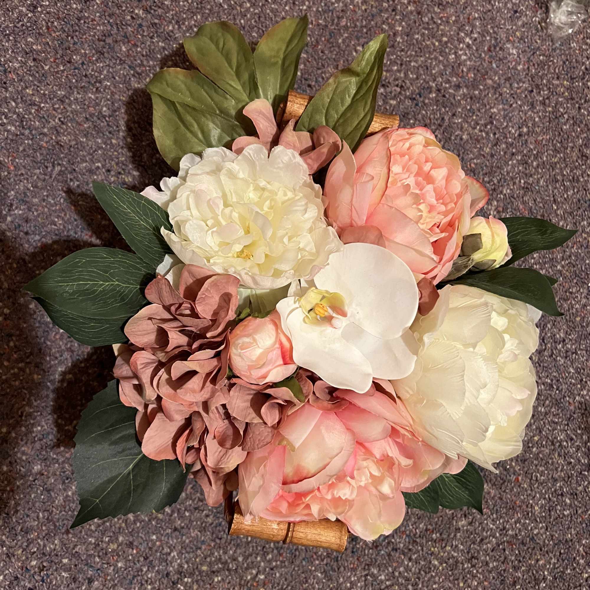 Bouquet of pink and white flowers with dark green leaves