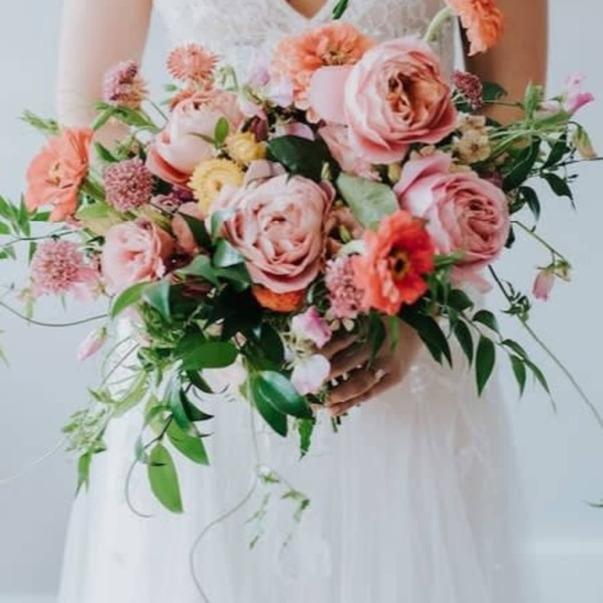 Bride holding a large pink and peach bouquet