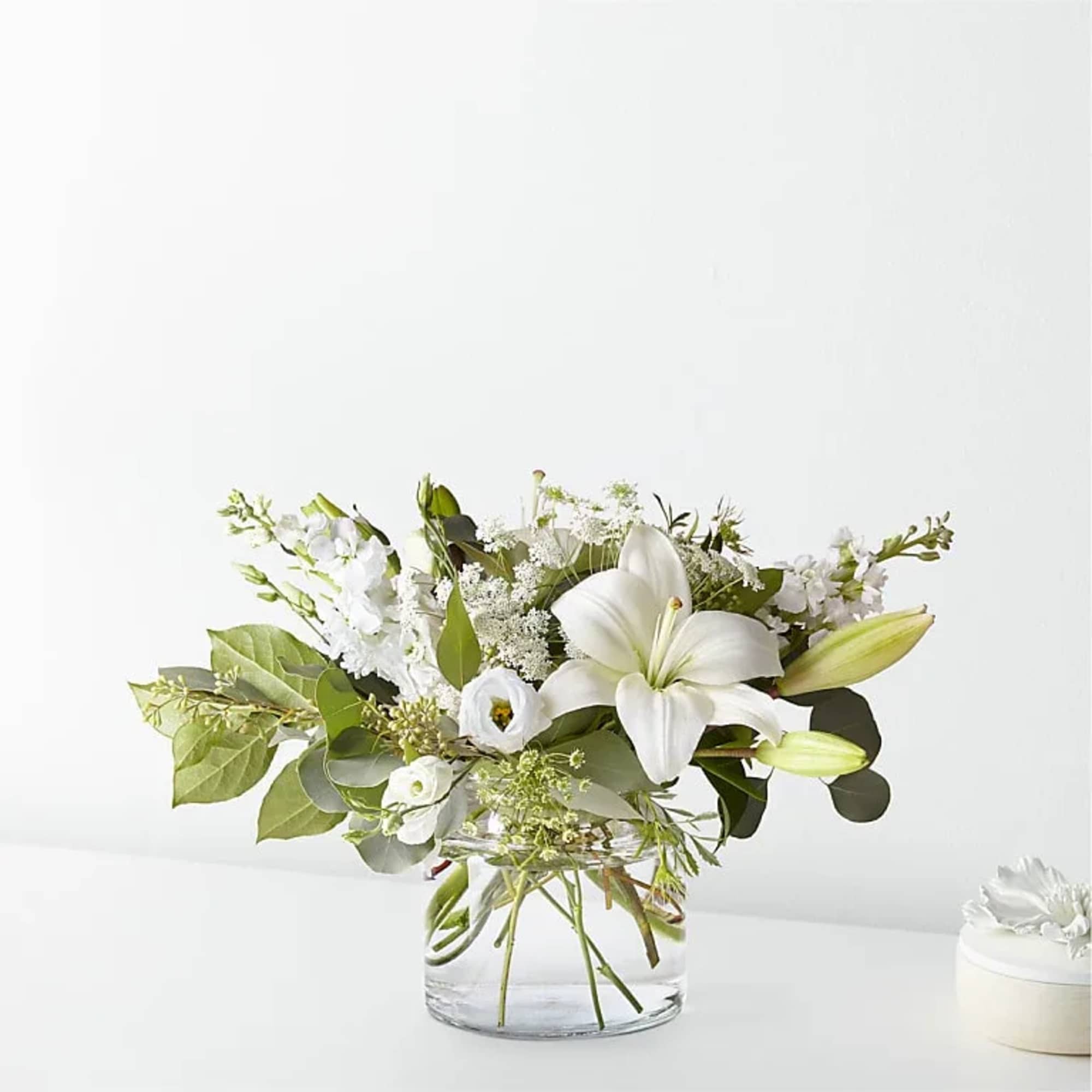 White floral arrangement in a clear glass vase
