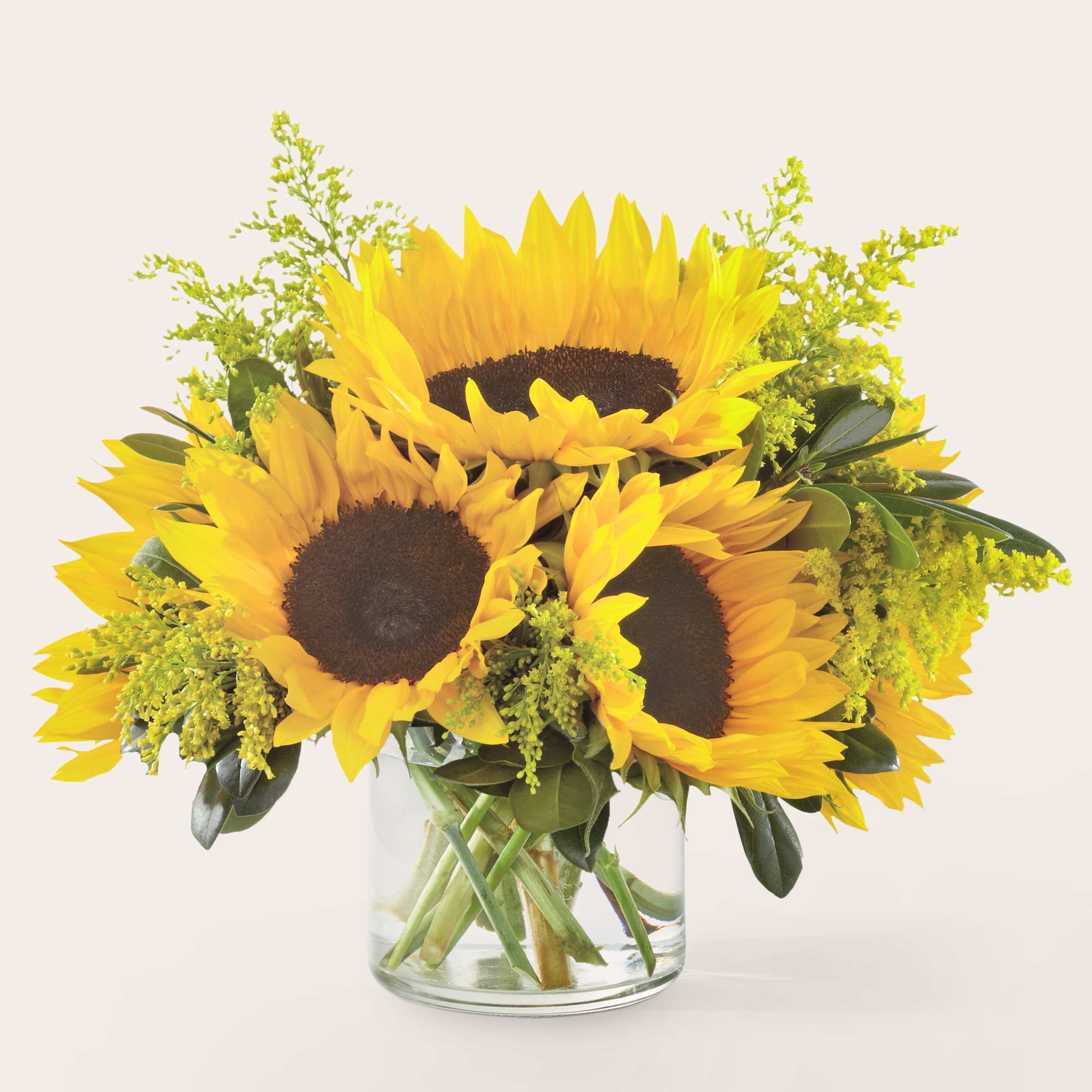 Bouquet of yellow sunflowers in a clear glass vase
