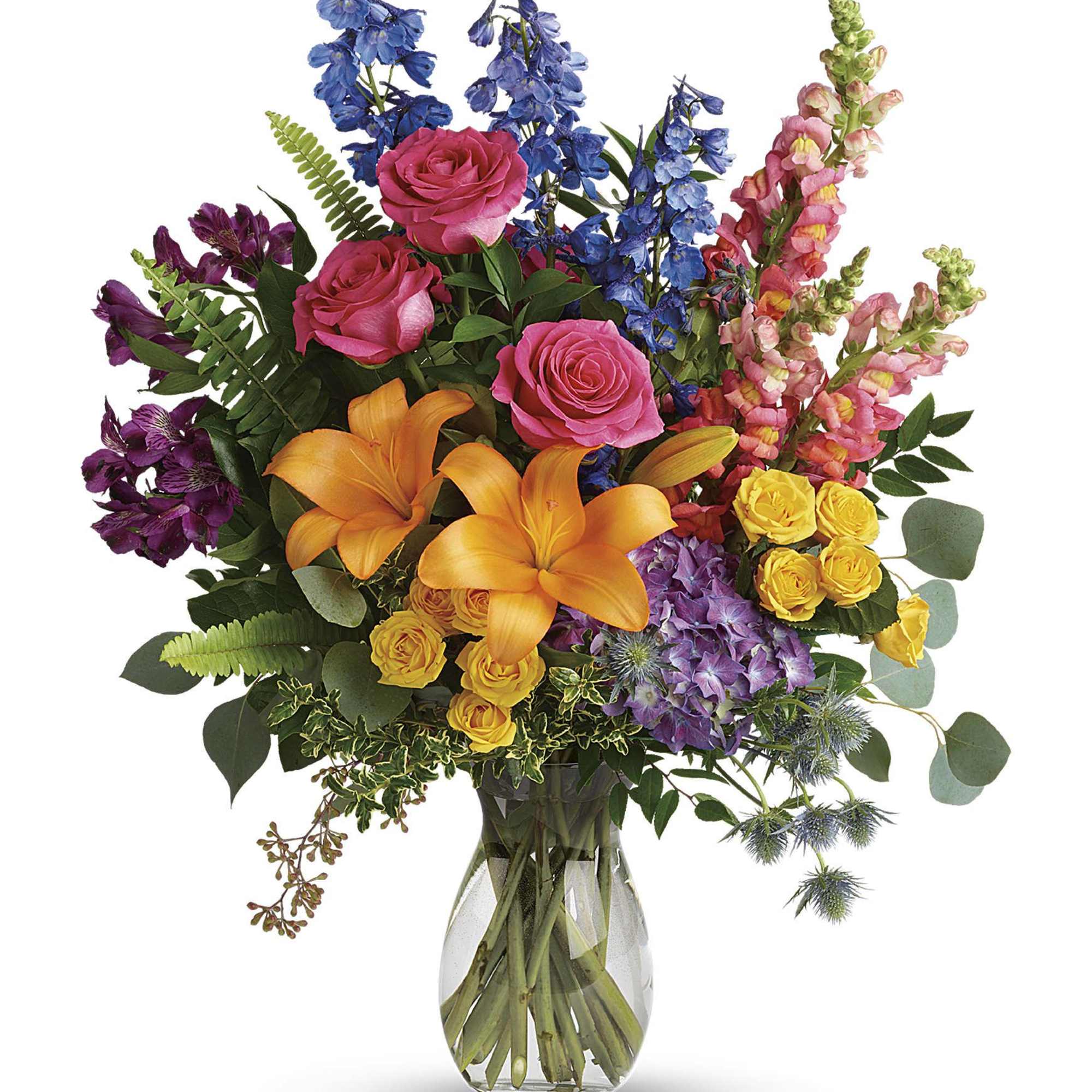 Colorful bouquet with roses, lilies, and snapdragons in a clear glass vase