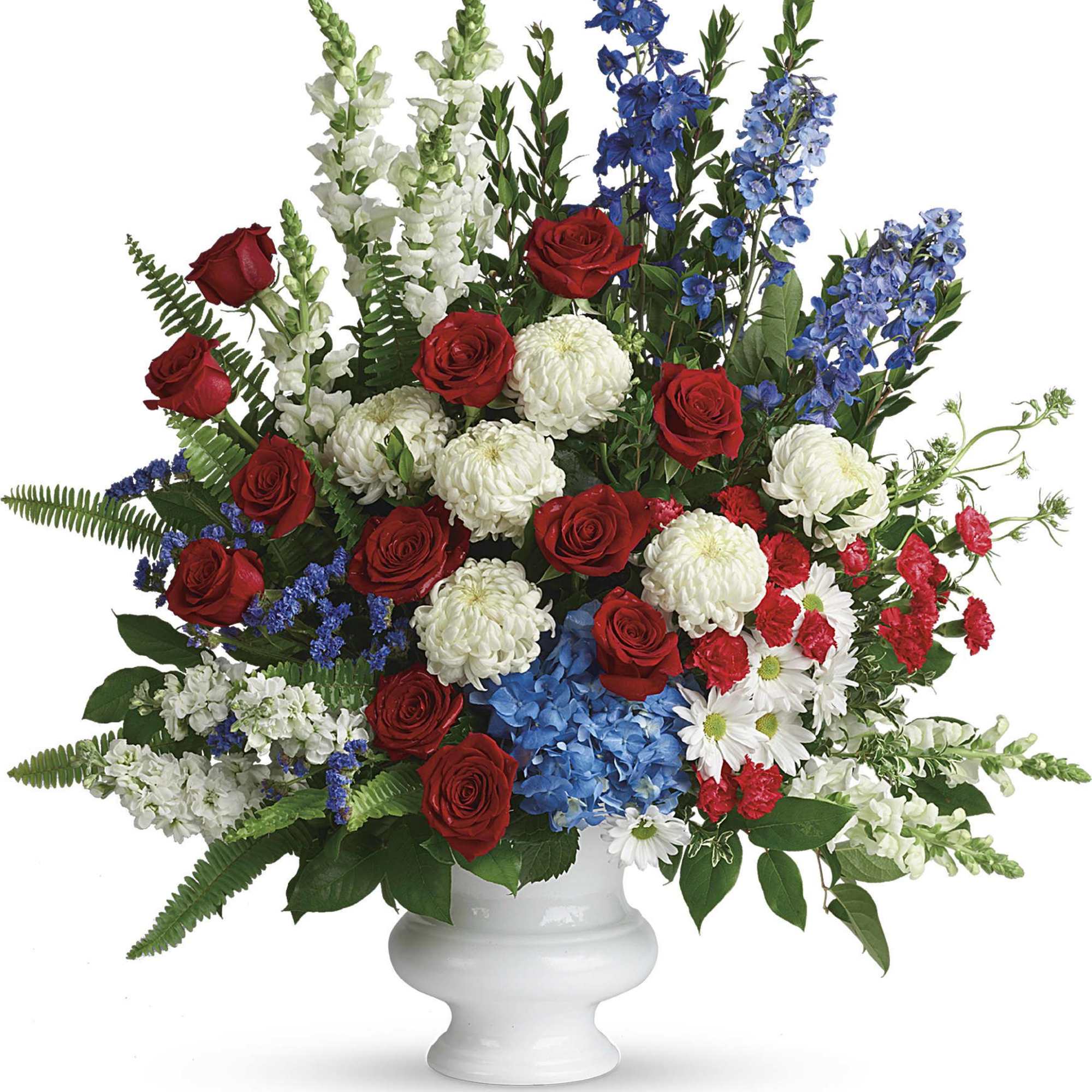 Mixed bouquet of red roses, white mums, and blue flowers in a white vase