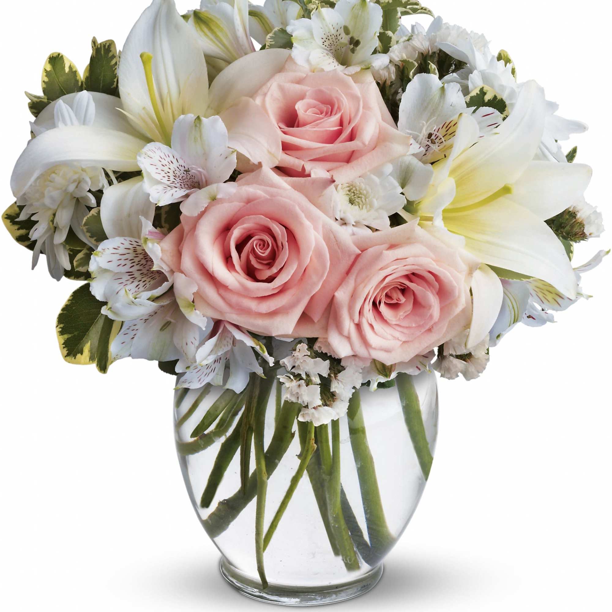 Pink roses and white lilies arranged in a clear glass vase