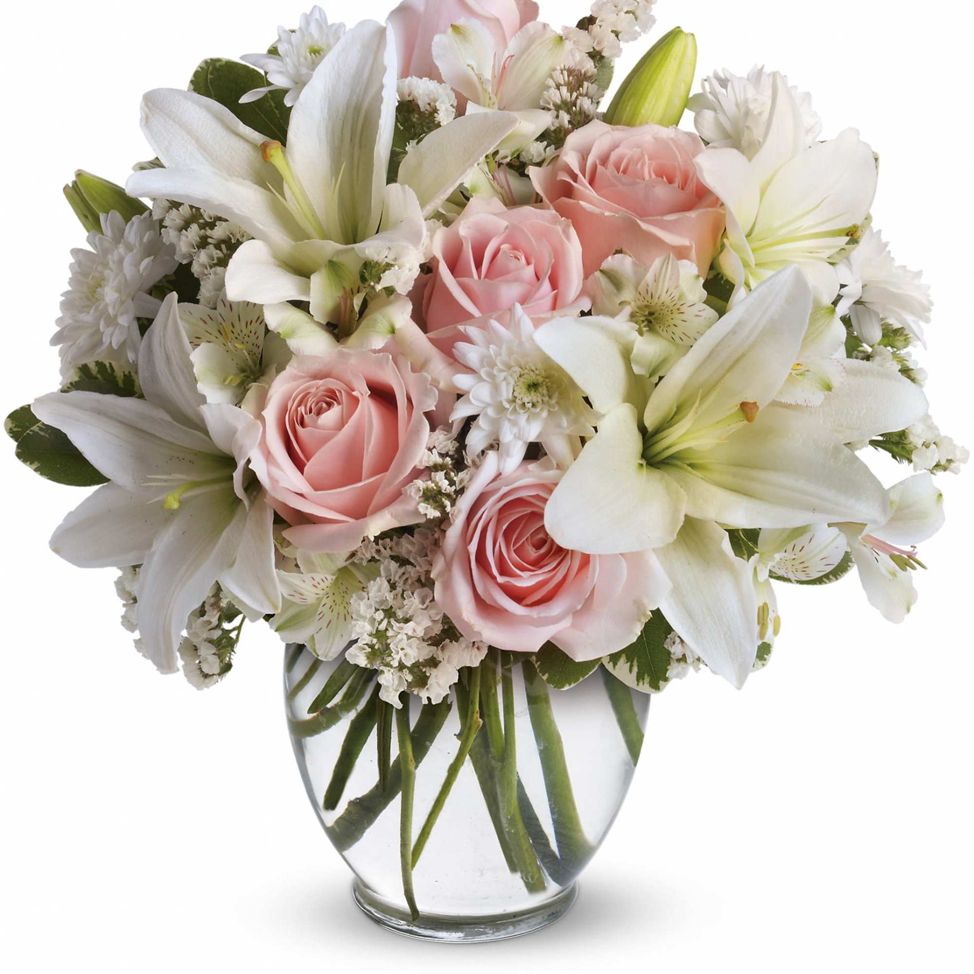 Pink roses and white lilies arranged in a clear glass vase