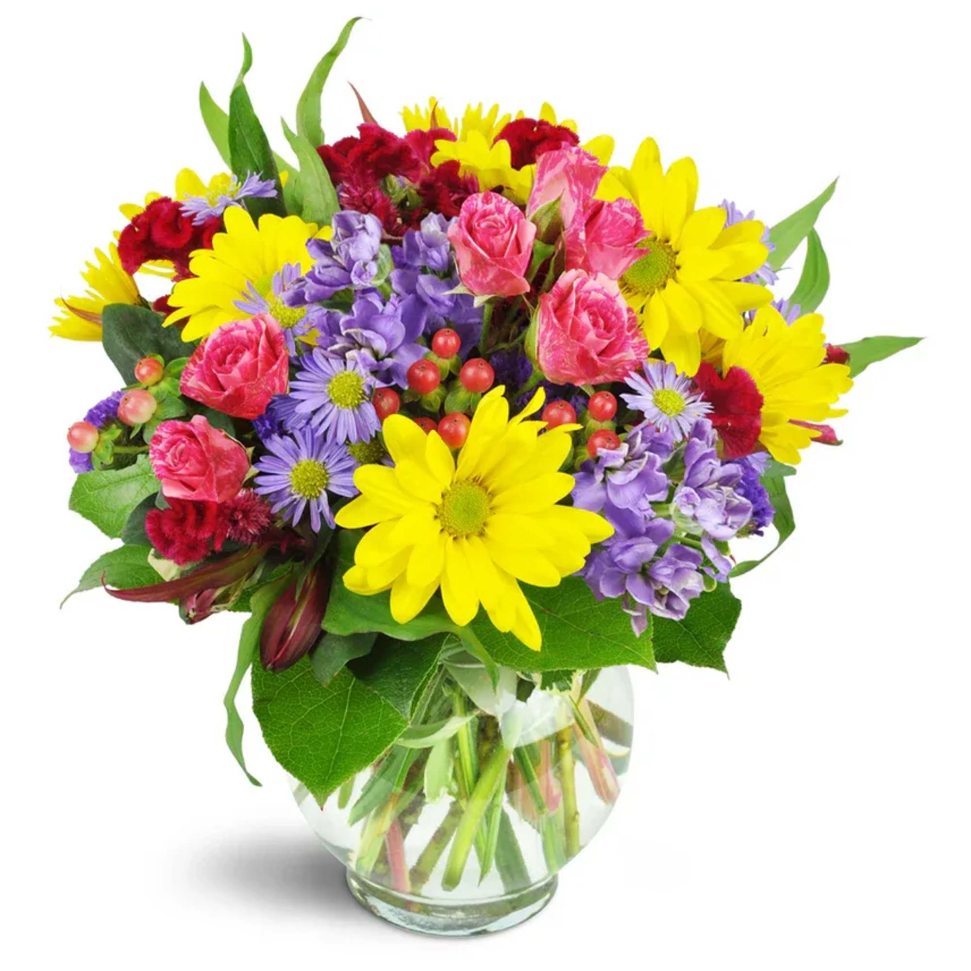 Mixed bouquet of yellow daisies, pink roses, and purple flowers in a glass vase