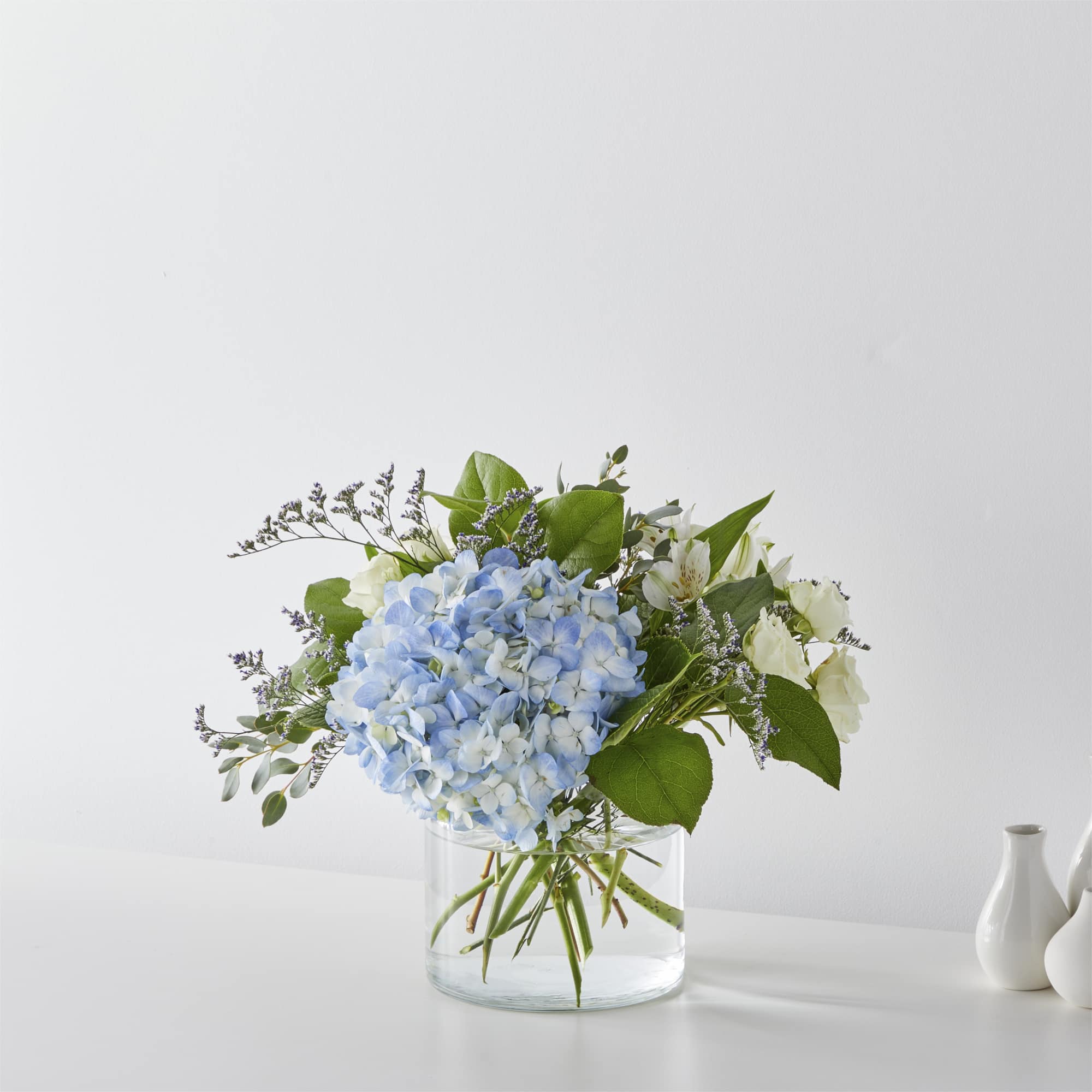 Open the shutters to the ocean breeze through the blue hydrangea, delphinium