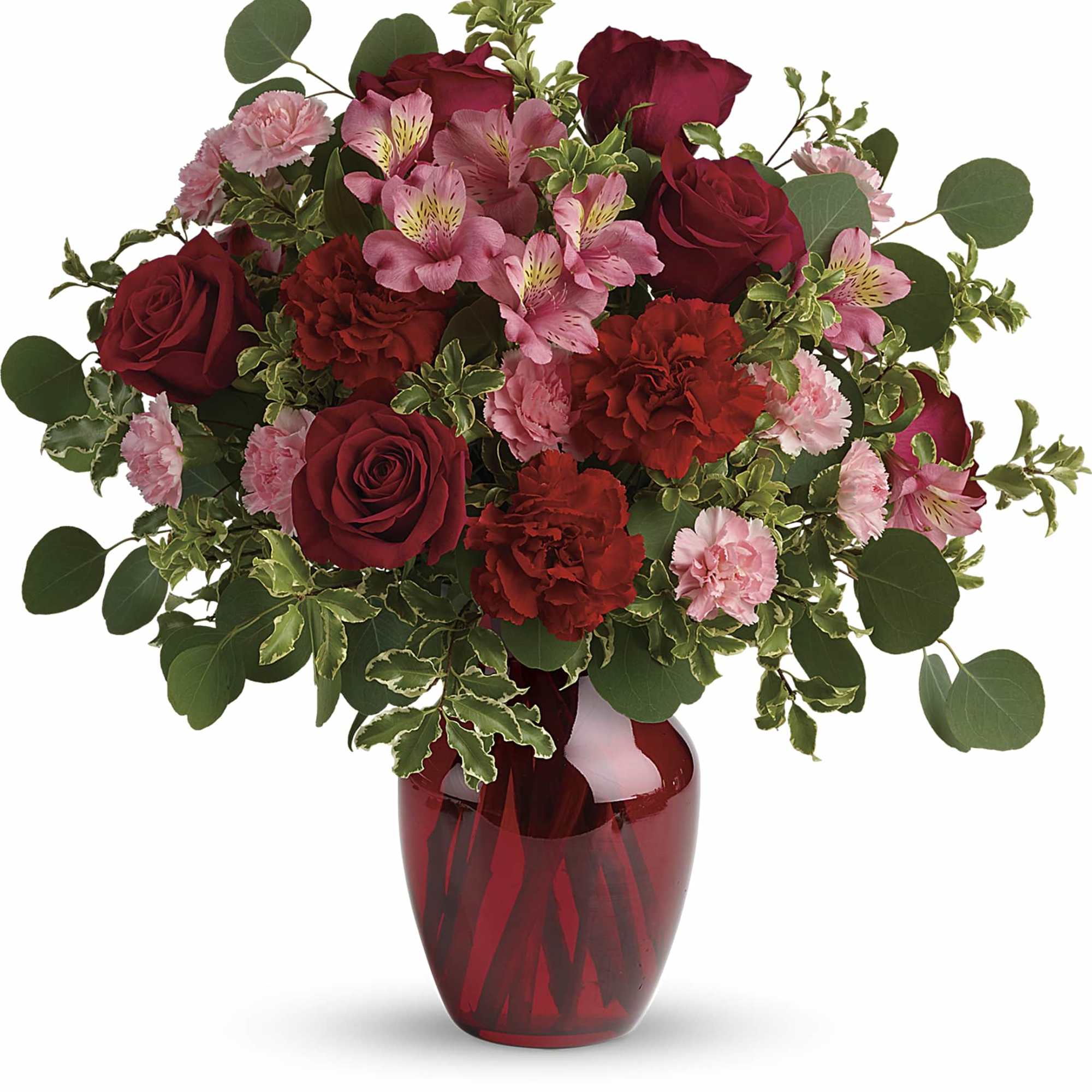 Red roses and pink flowers arranged in a red glass vase