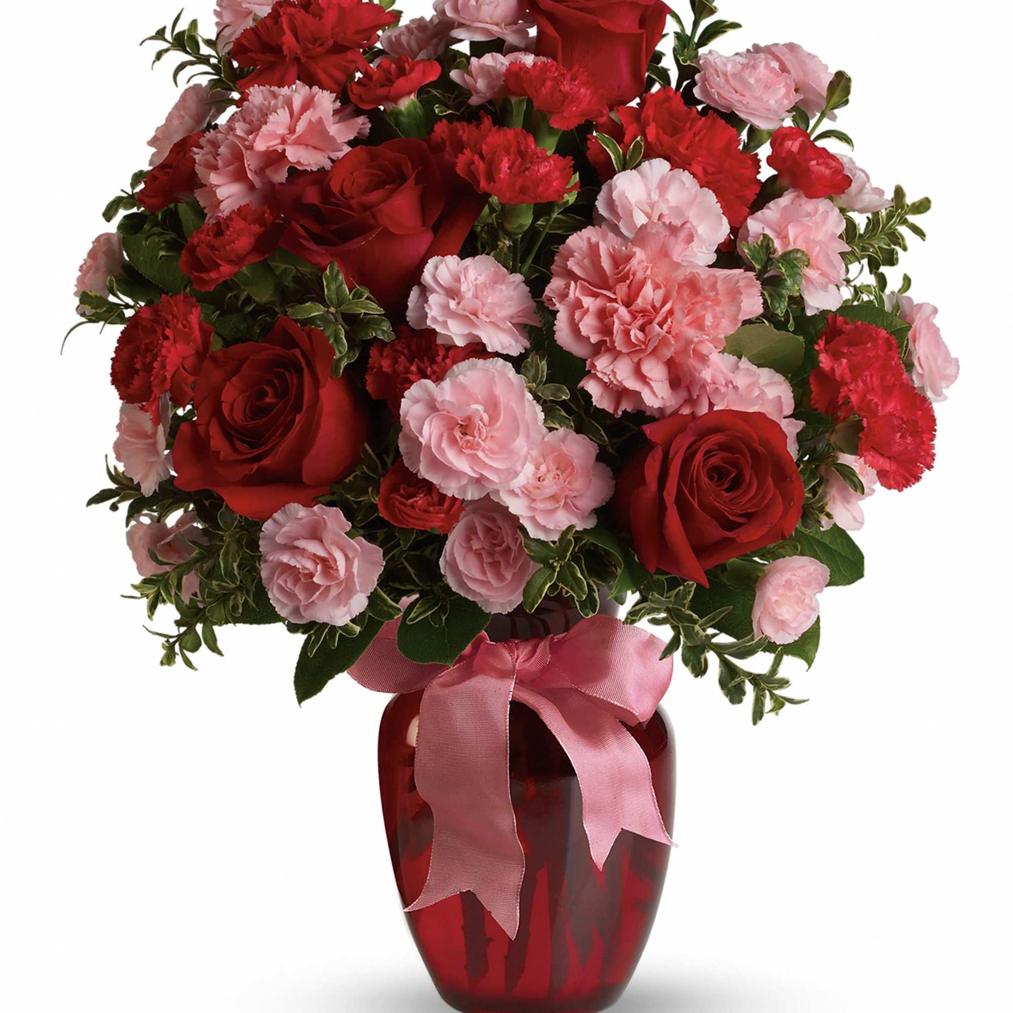 Red roses and pink carnations in a red glass vase with a pink ribbon