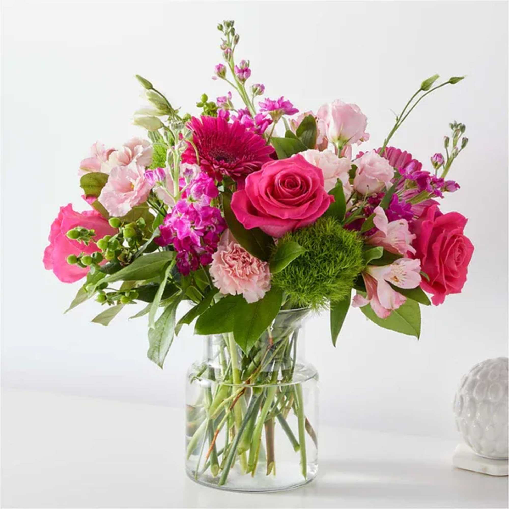 Pink and magenta mixed bouquet in a clear glass vase