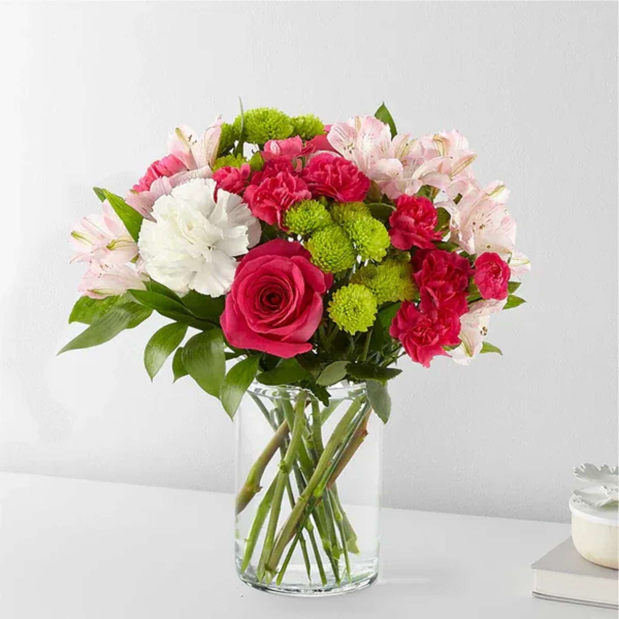 Bouquet of pink and white flowers in a clear glass vase