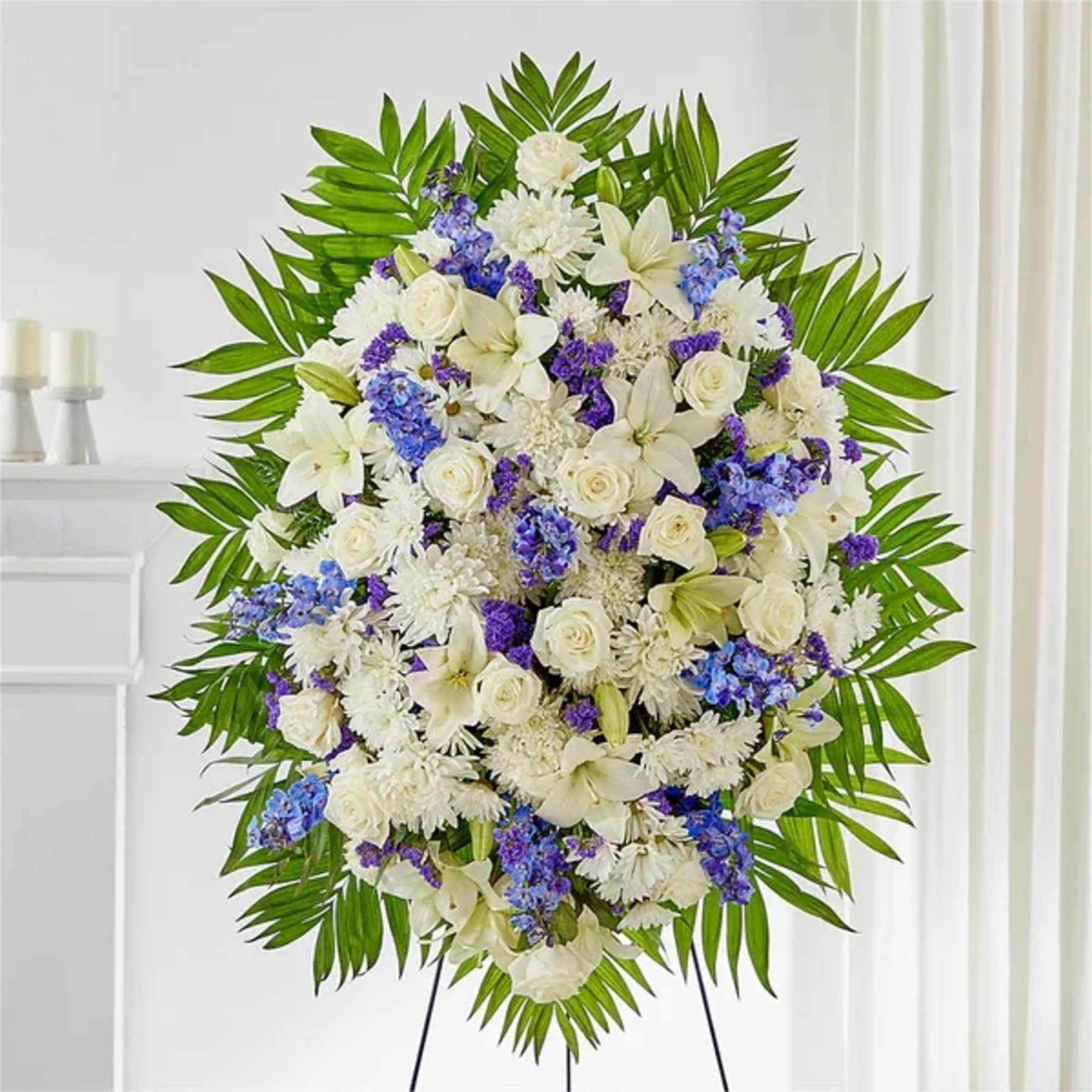 Large white and purple floral standing spray on an easel