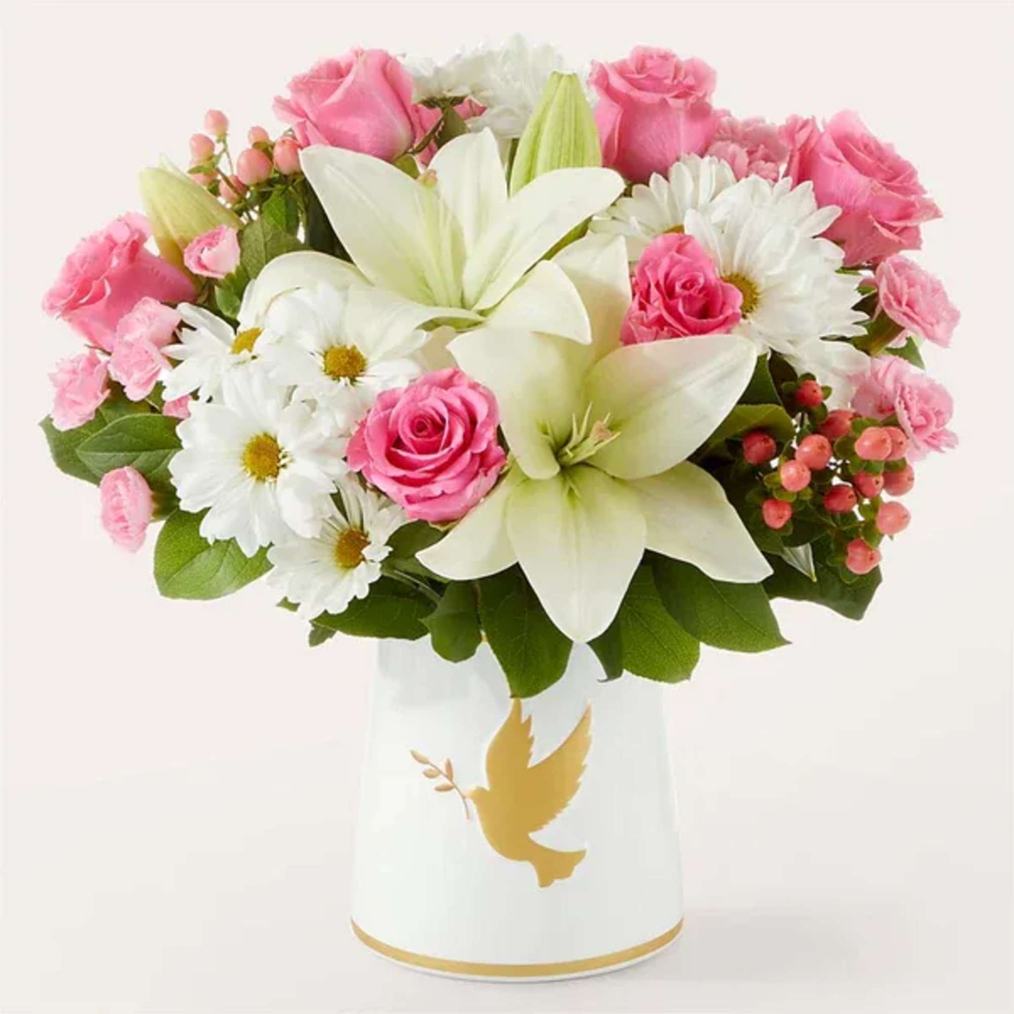 Pink roses and white lilies in a white vase with a gold dove design