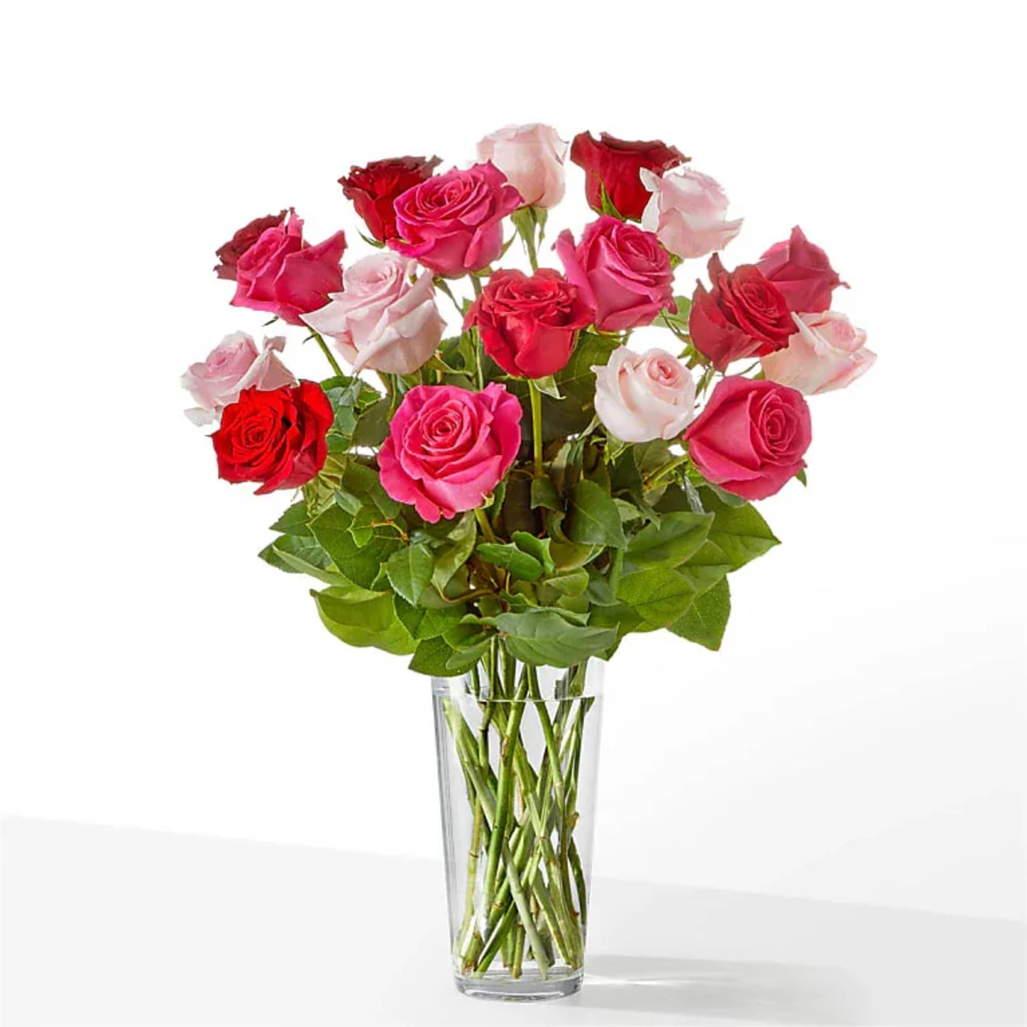 Bouquet of pink and red roses in a clear glass vase