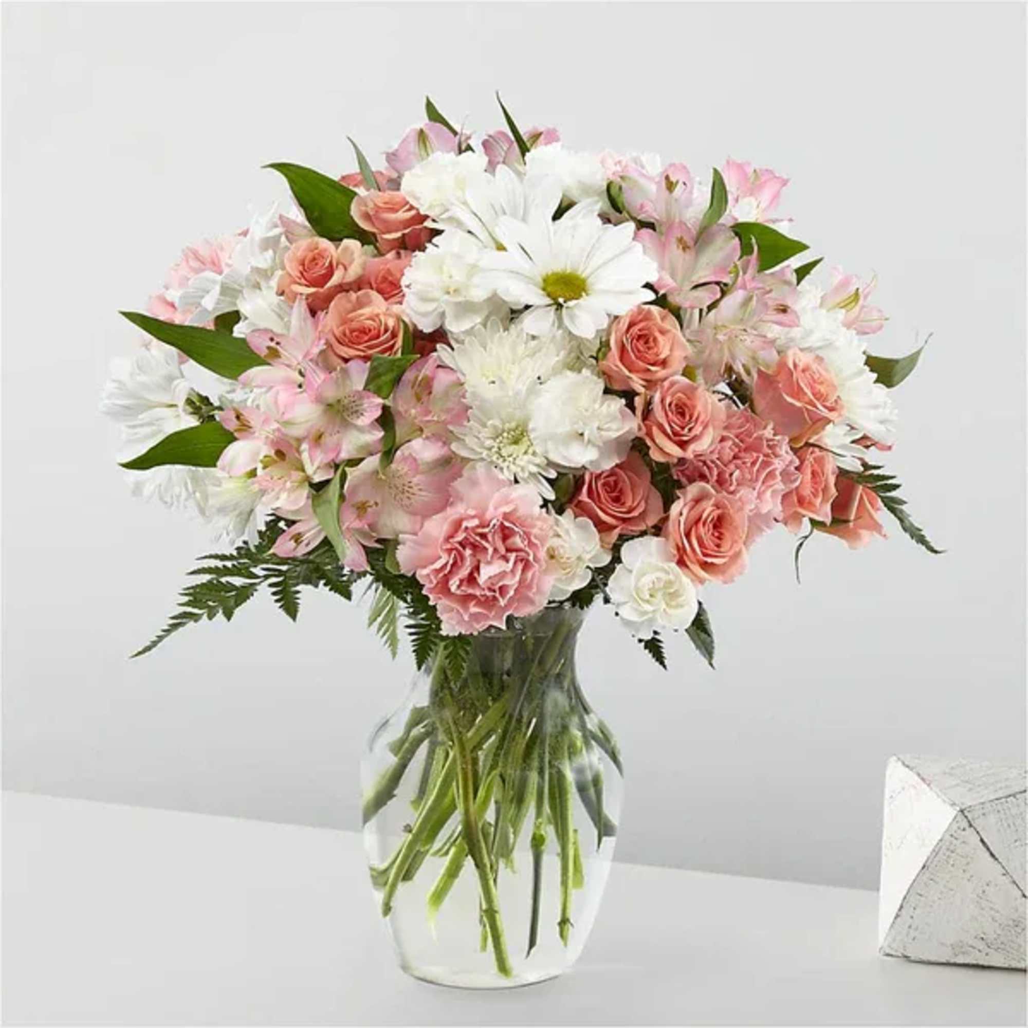Pink and white mixed flower bouquet in a clear glass vase