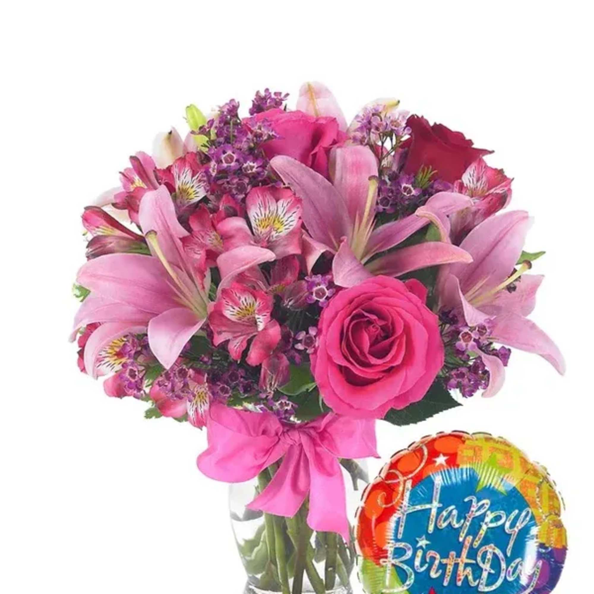Pink mixed bouquet in a glass vase with a birthday balloon