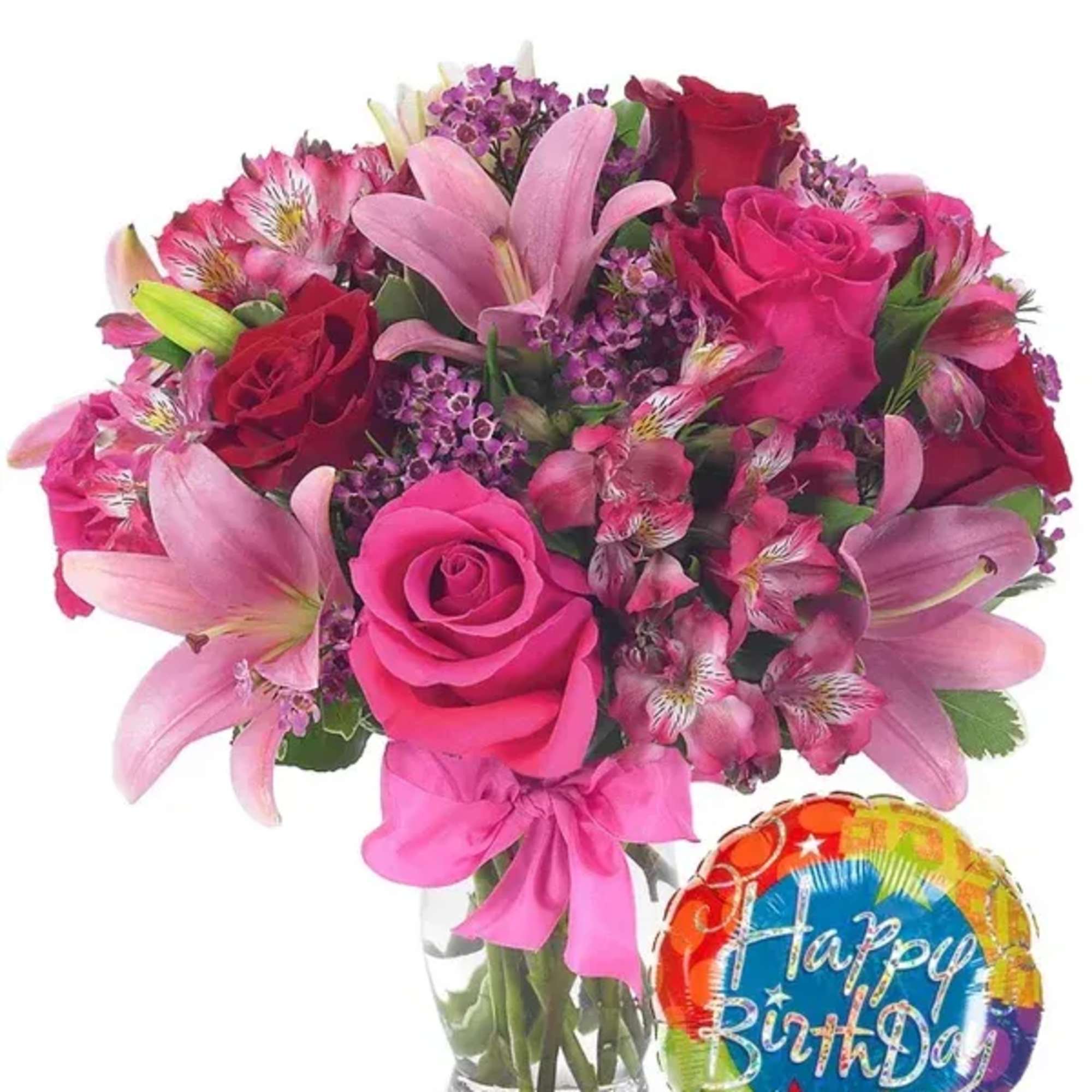 Pink and red bouquet in a glass vase with a birthday balloon