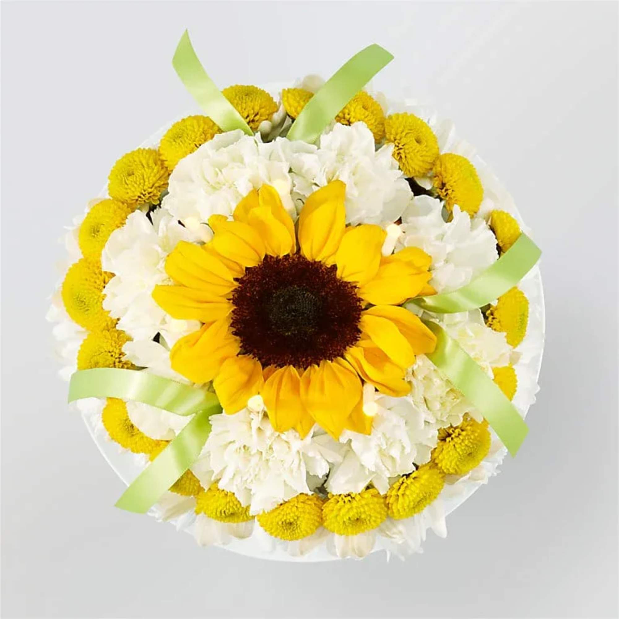 Round bouquet with a sunflower center, white flowers, and yellow blooms