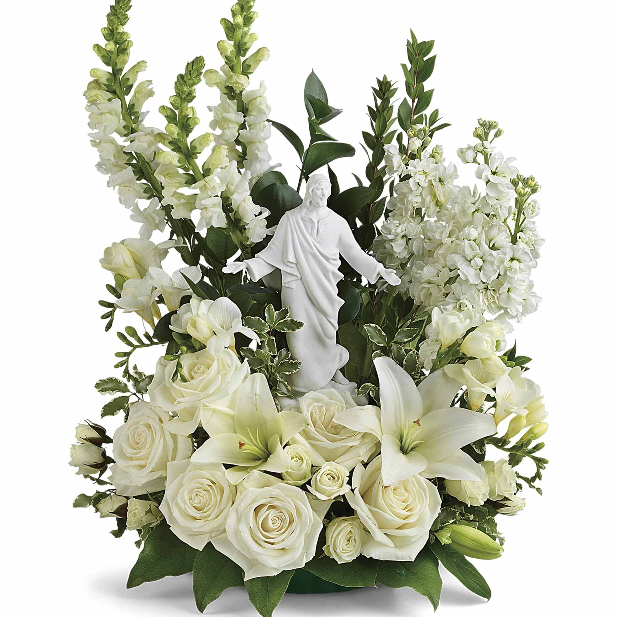 White floral arrangement with a statue of Jesus in the center