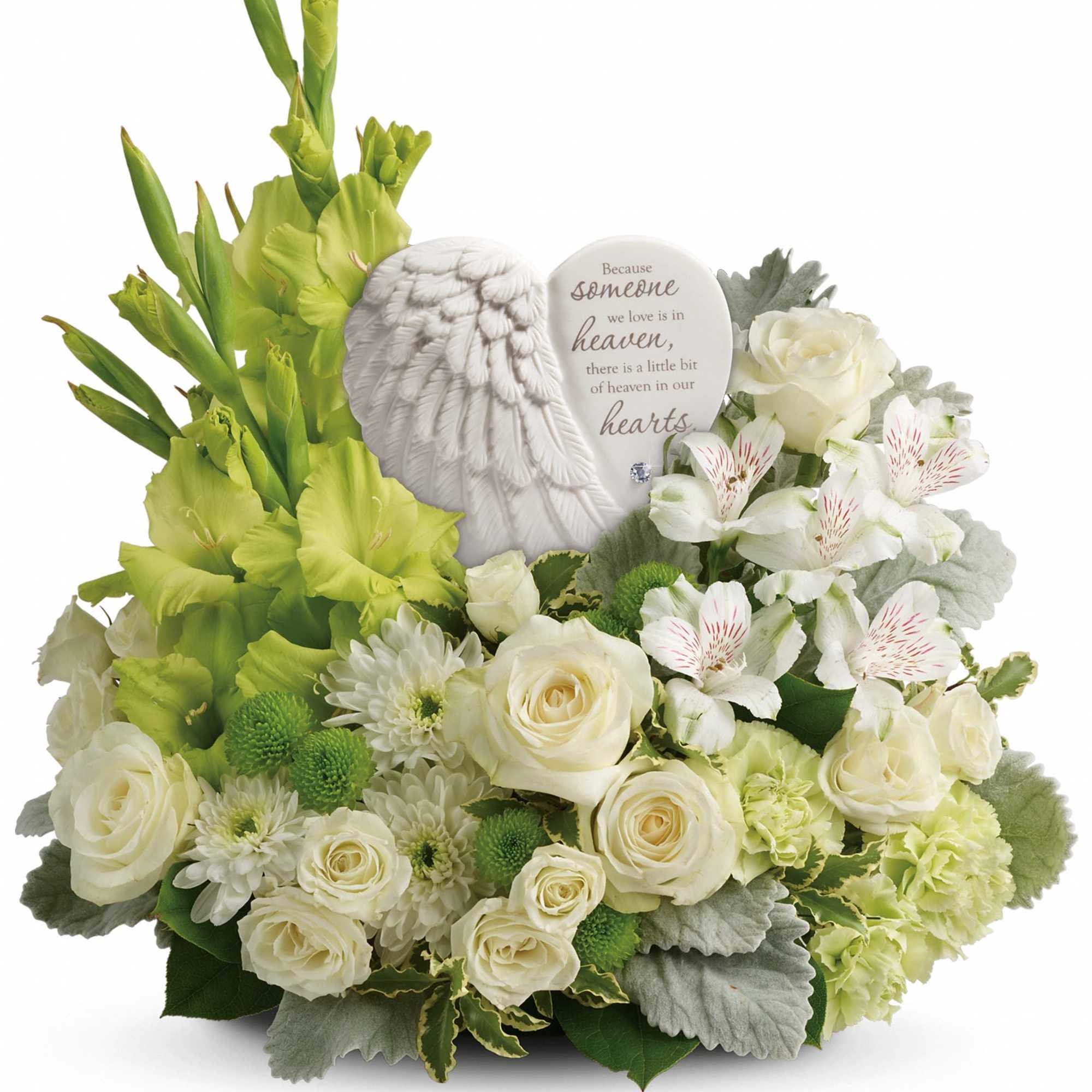 White roses and green flowers arranged with a memorial angel plaque