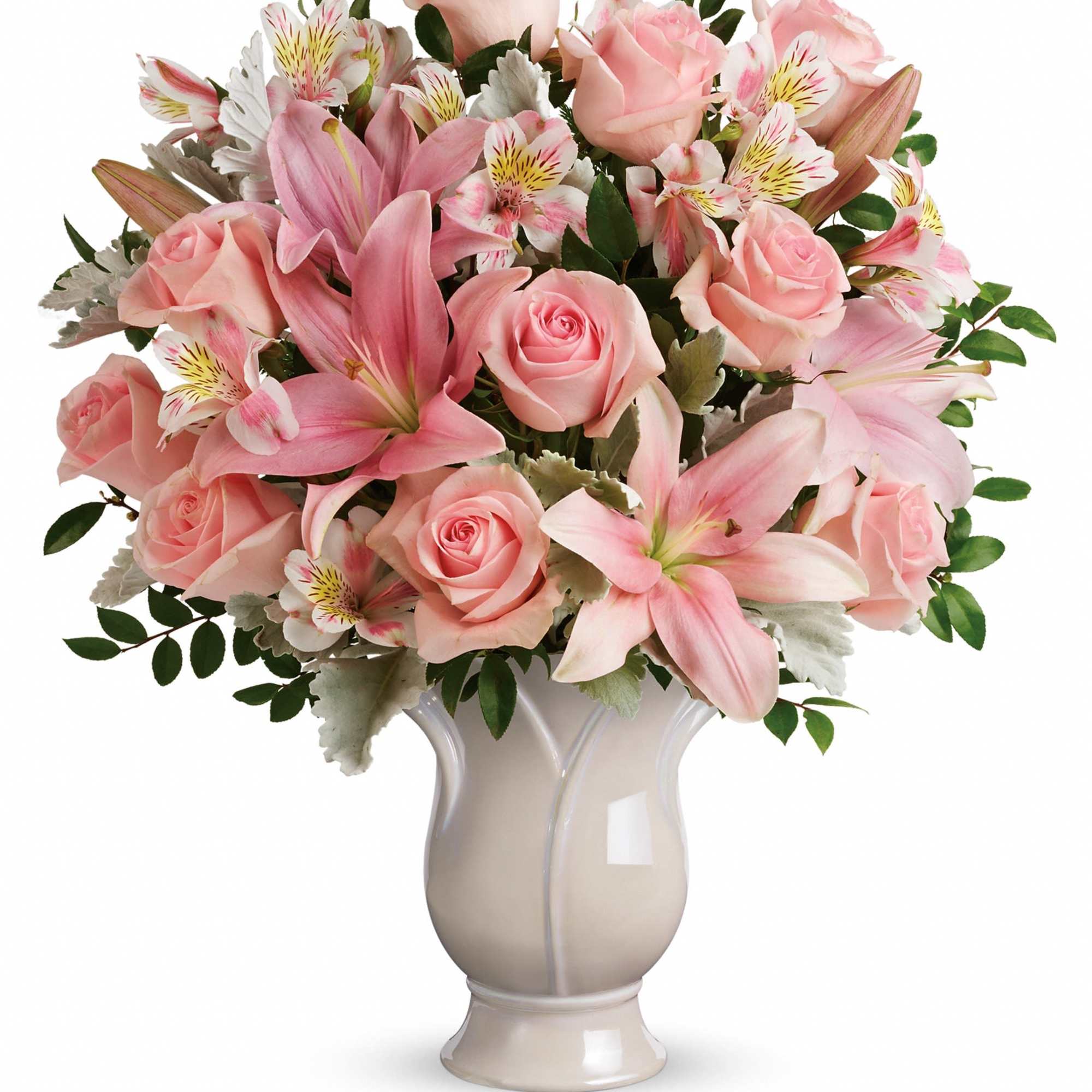 Pink roses and lilies arranged in a white vase
