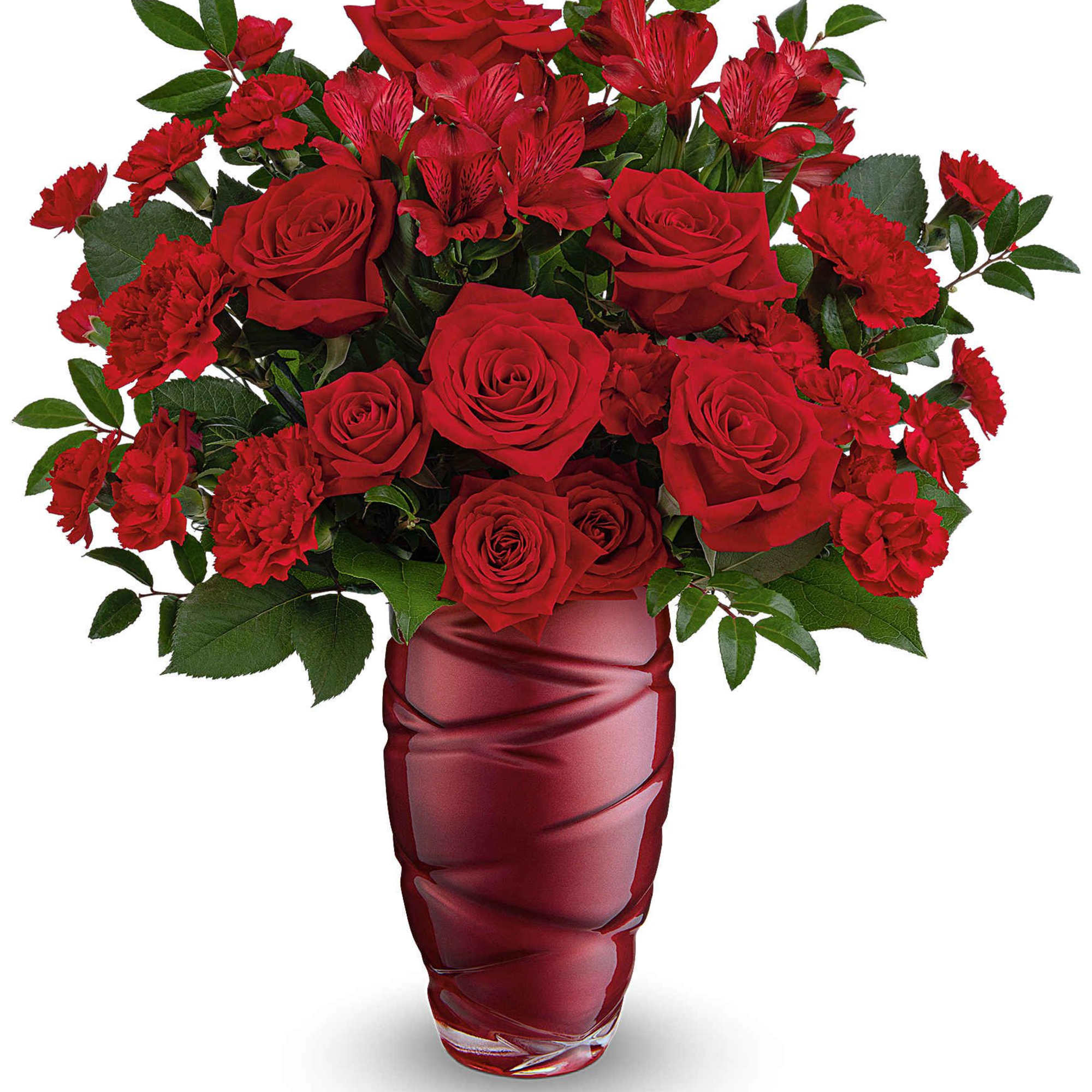 Red roses and carnations arranged in a red glass vase
