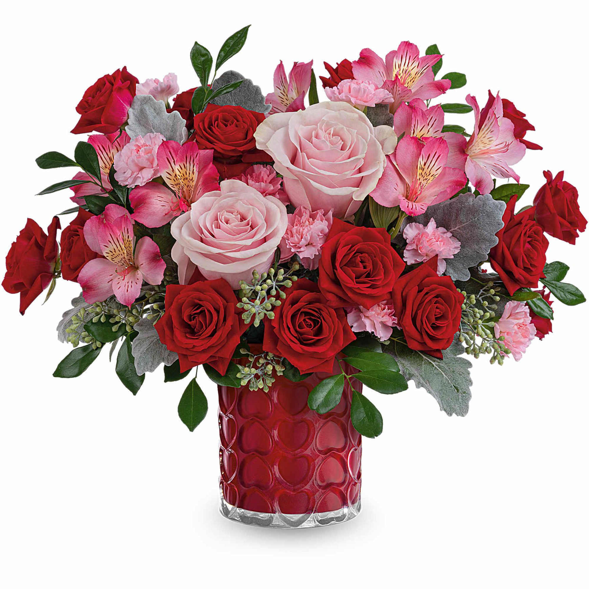 Red and pink rose bouquet in a red heart-pattern vase