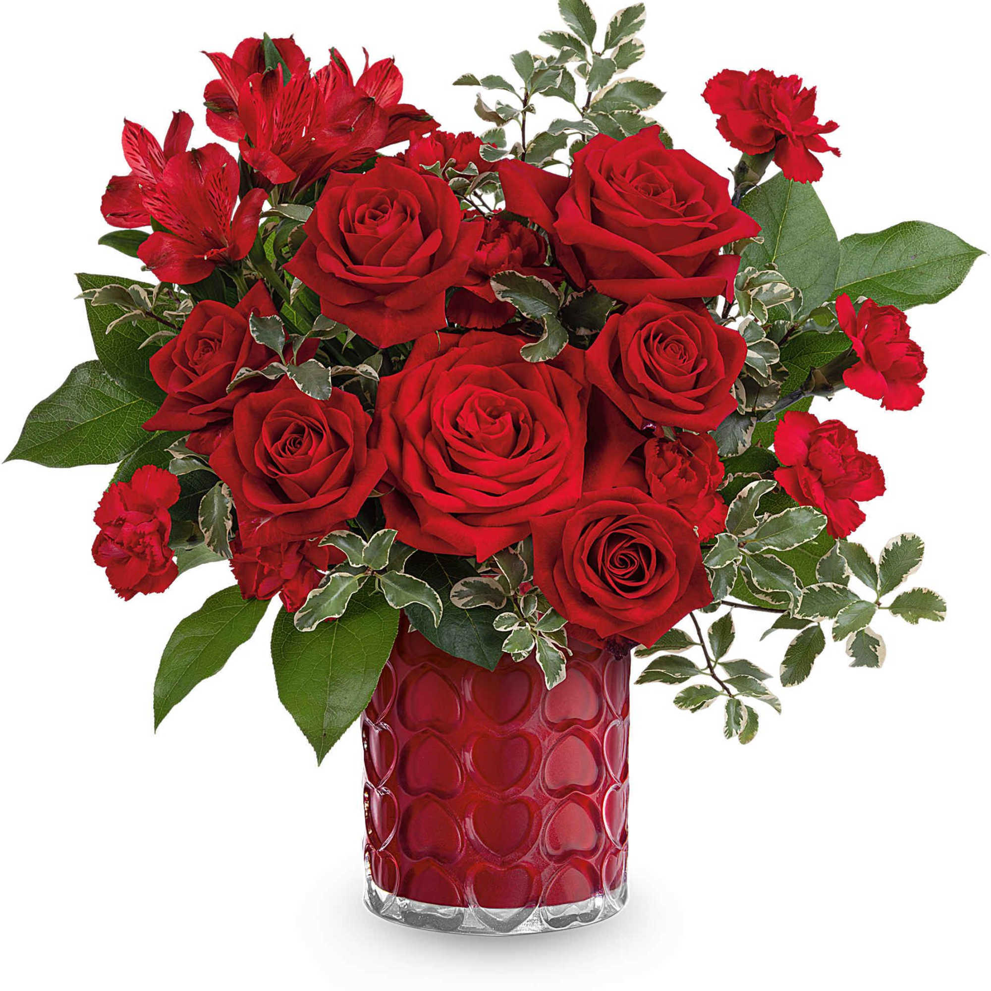 Red roses and carnations in a red heart-patterned vase