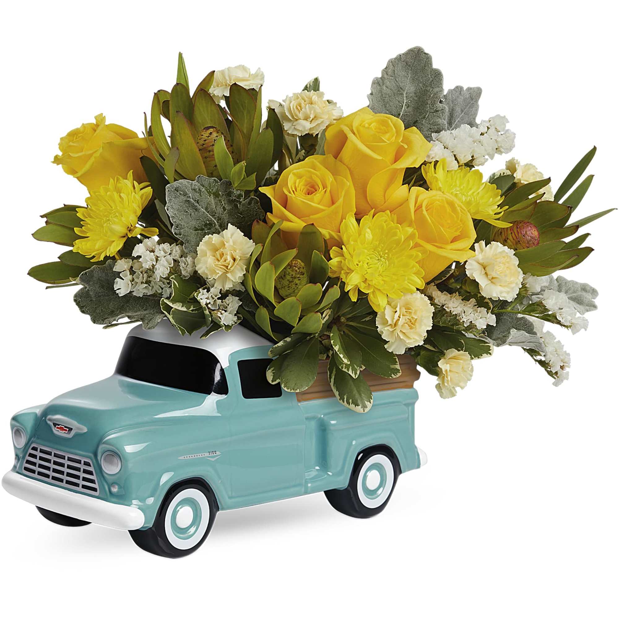 Yellow roses and mums arranged in a turquoise ceramic truck