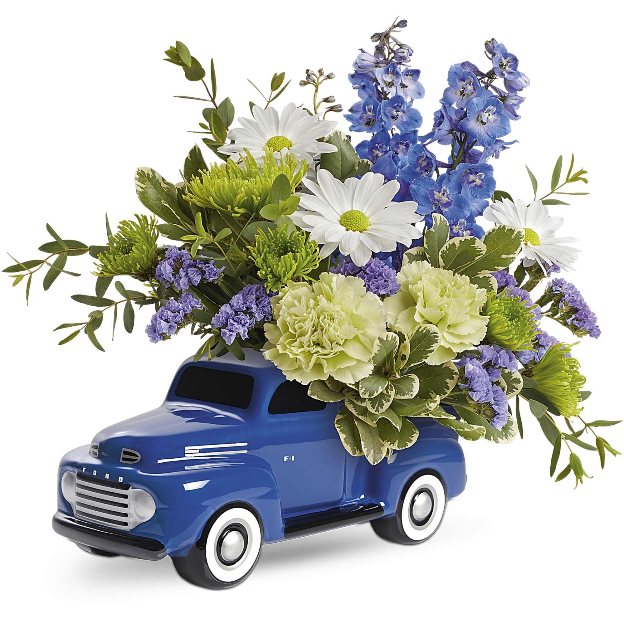 Blue toy truck filled with white, blue, and green flowers