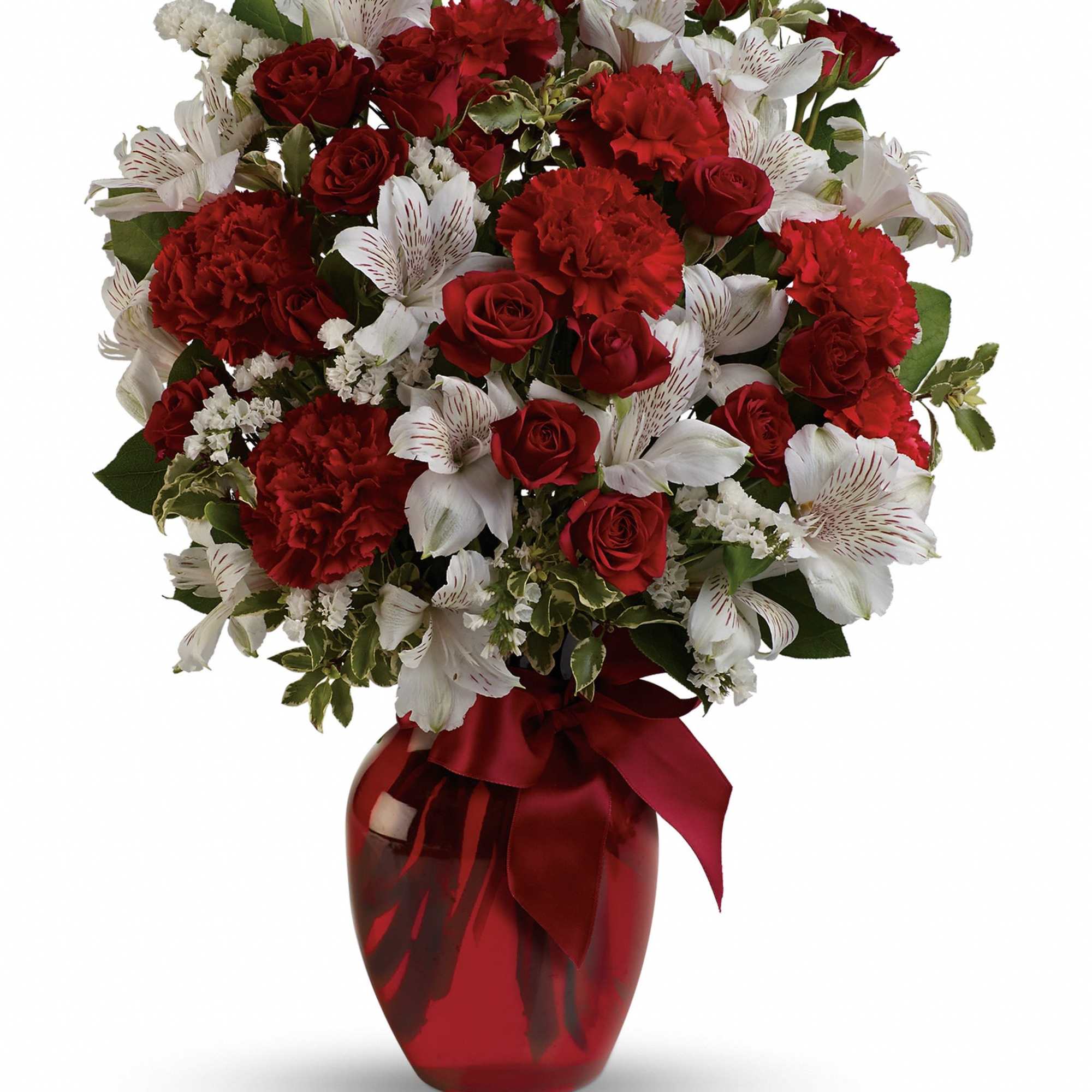 Red roses and white alstroemeria in a red vase with a ribbon