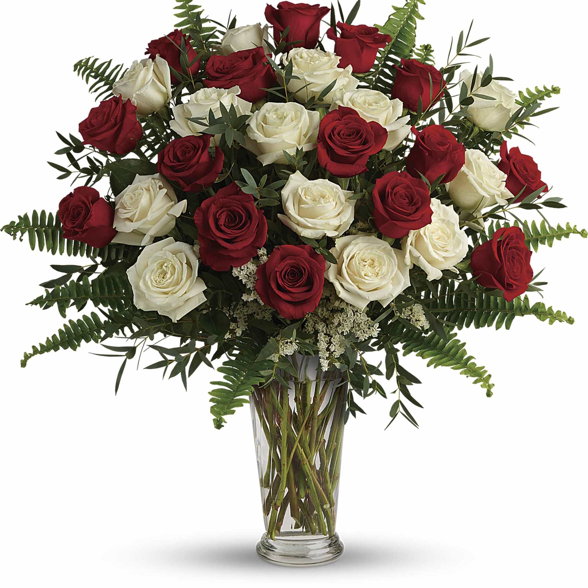 Red and white roses arranged in a clear glass vase