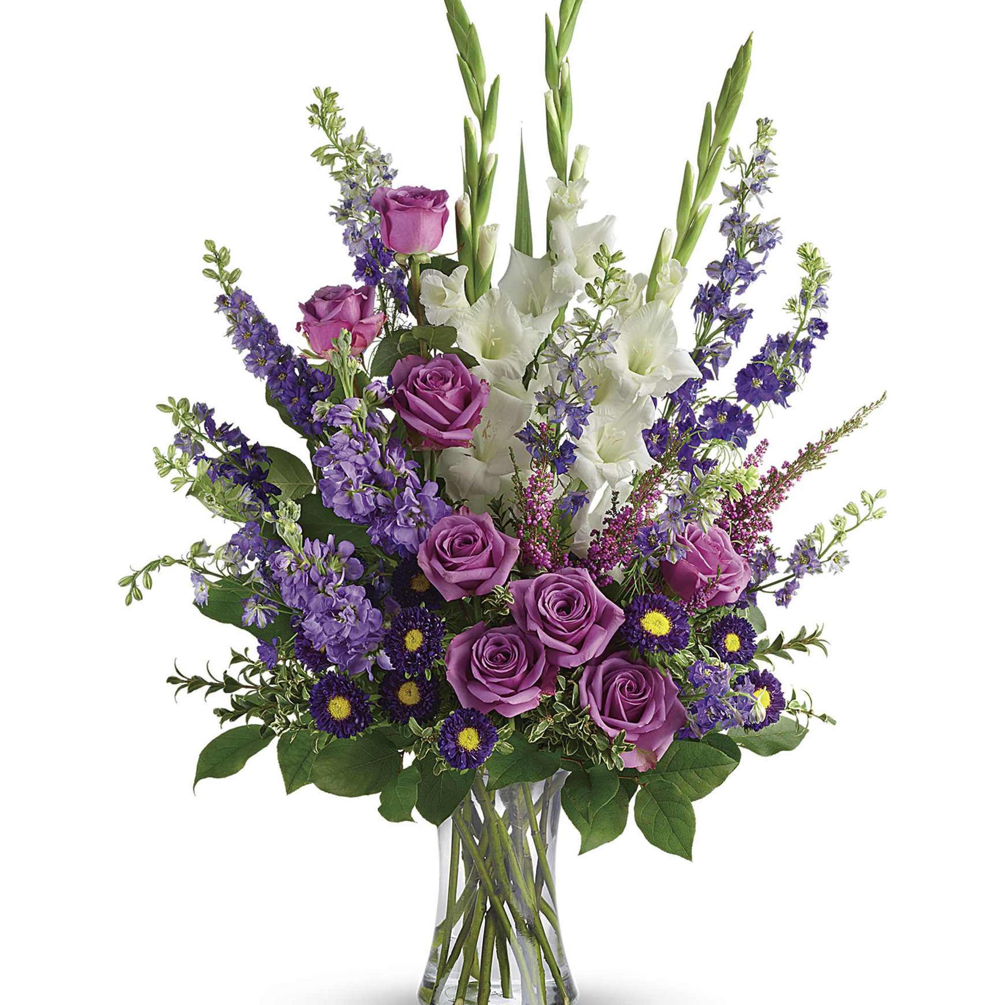 Purple roses and white gladiolus in a clear glass vase