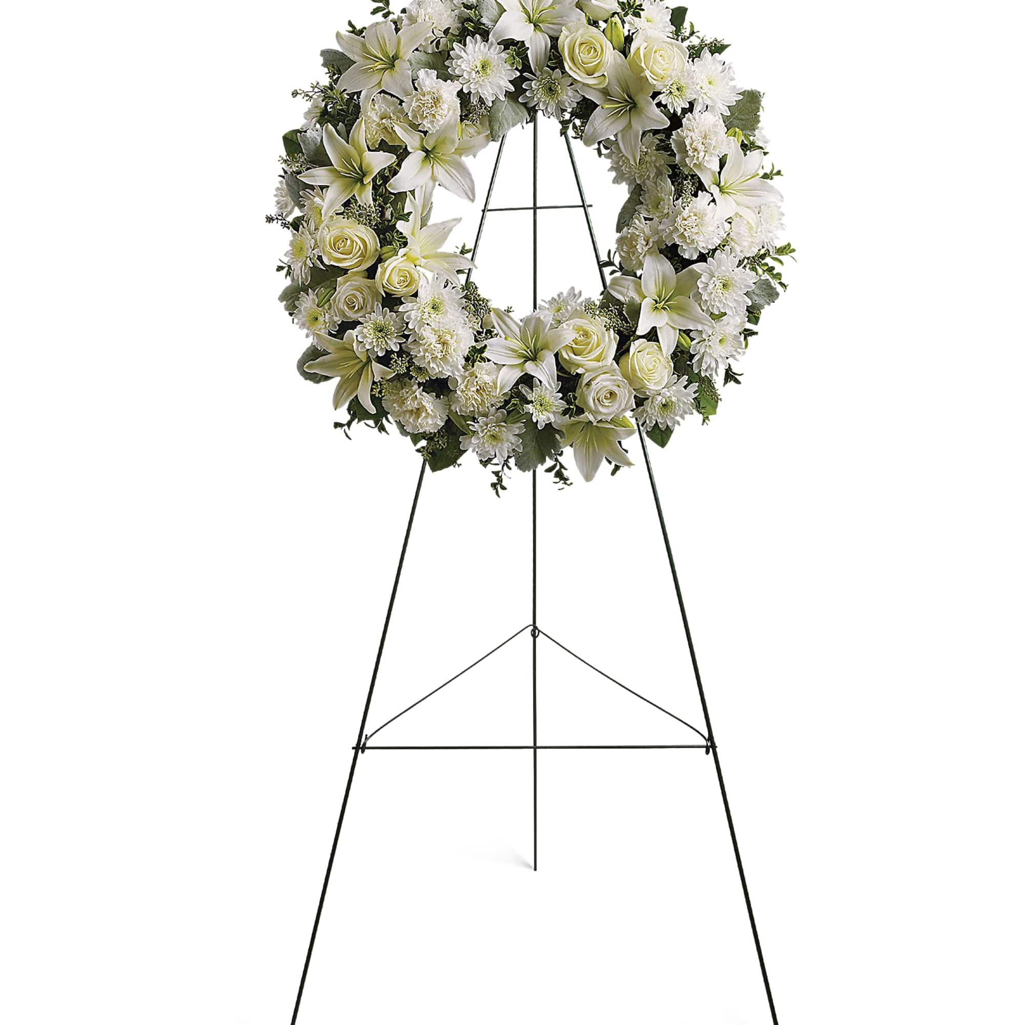 White floral wreath on a black standing easel