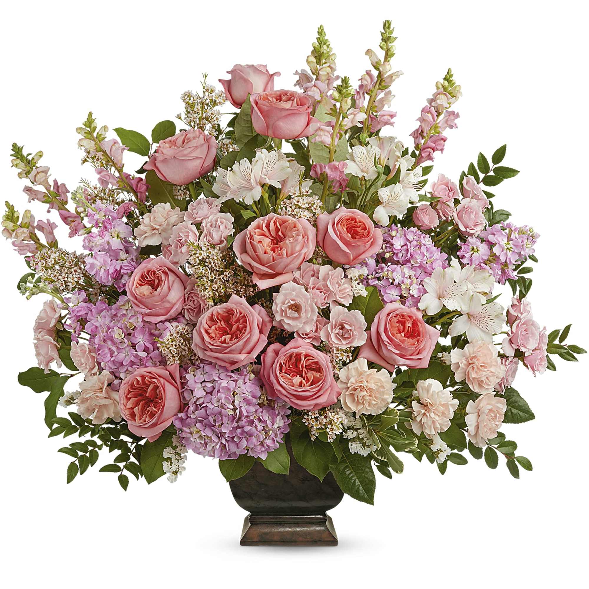 Pink roses and mixed blooms arranged in a dark urn vase