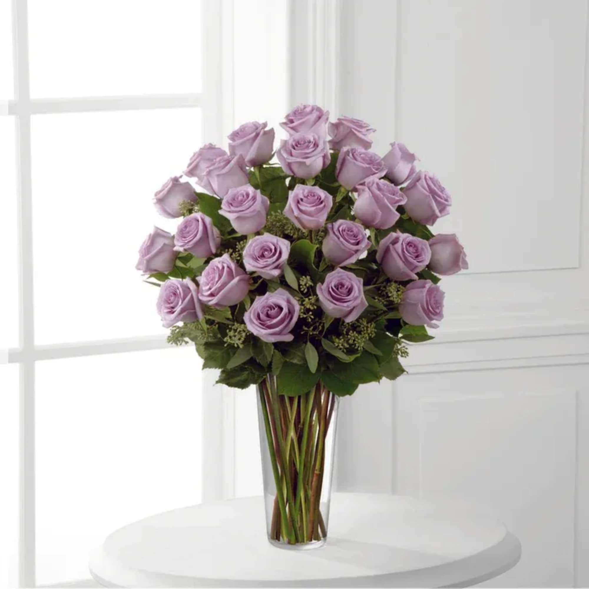 Lavender rose bouquet in a clear glass vase