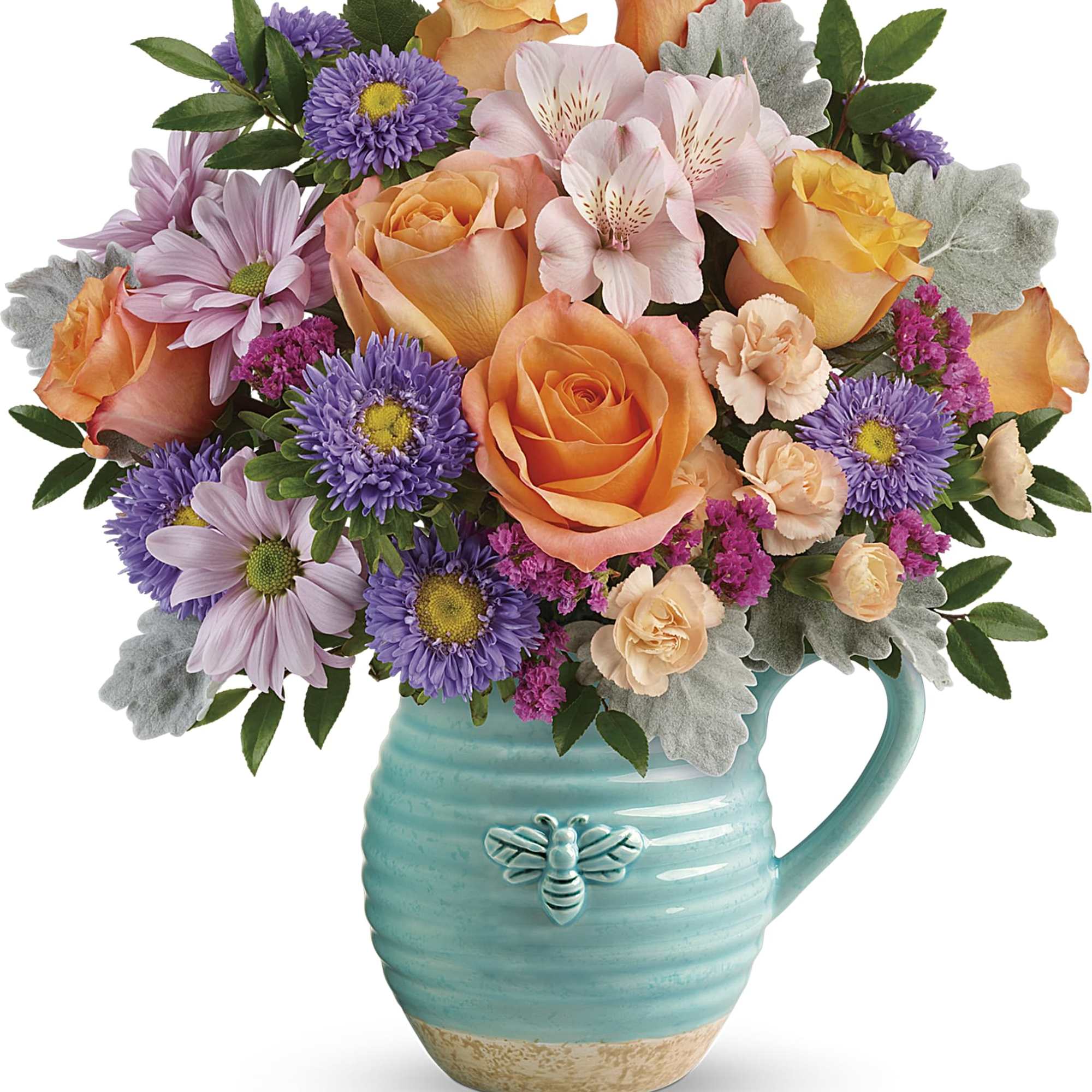 Mixed bouquet of orange roses, purple daisies, and pink flowers in a turquoise pitcher vase
