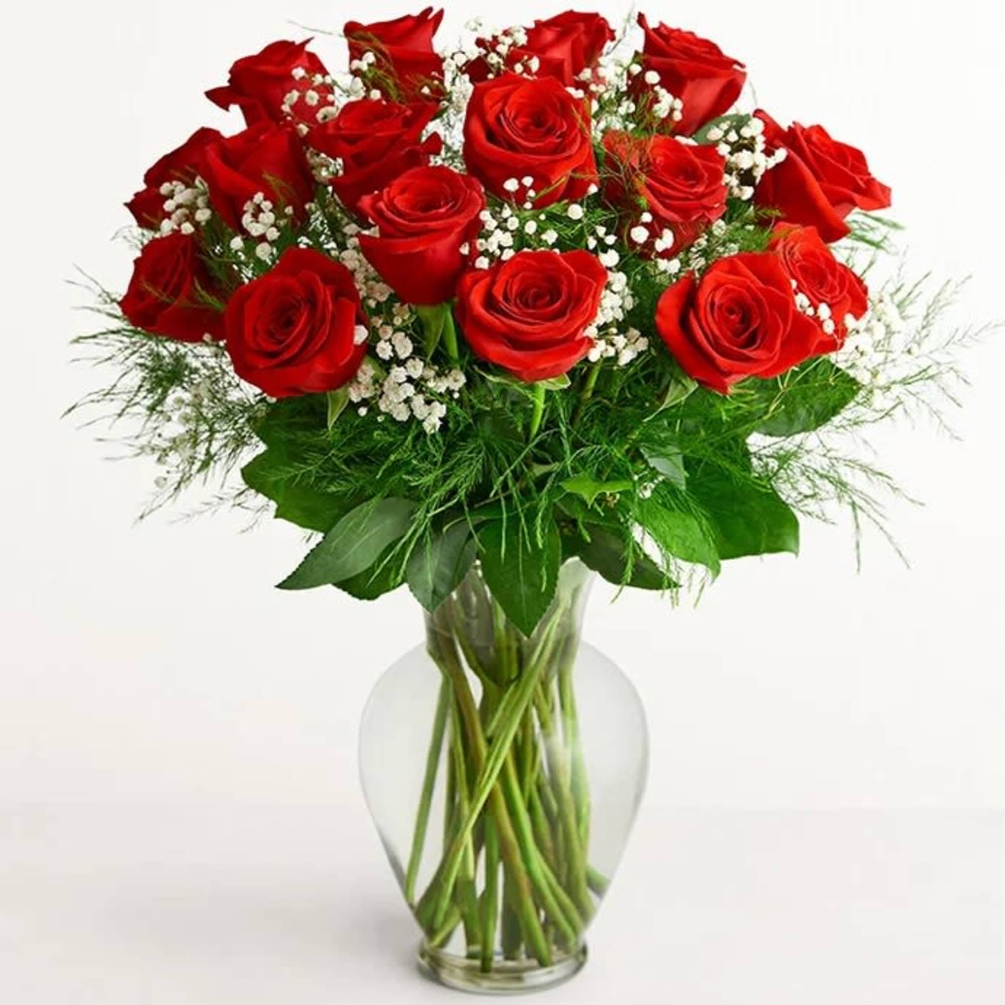 Bouquet of red roses with baby's breath in a clear glass vase