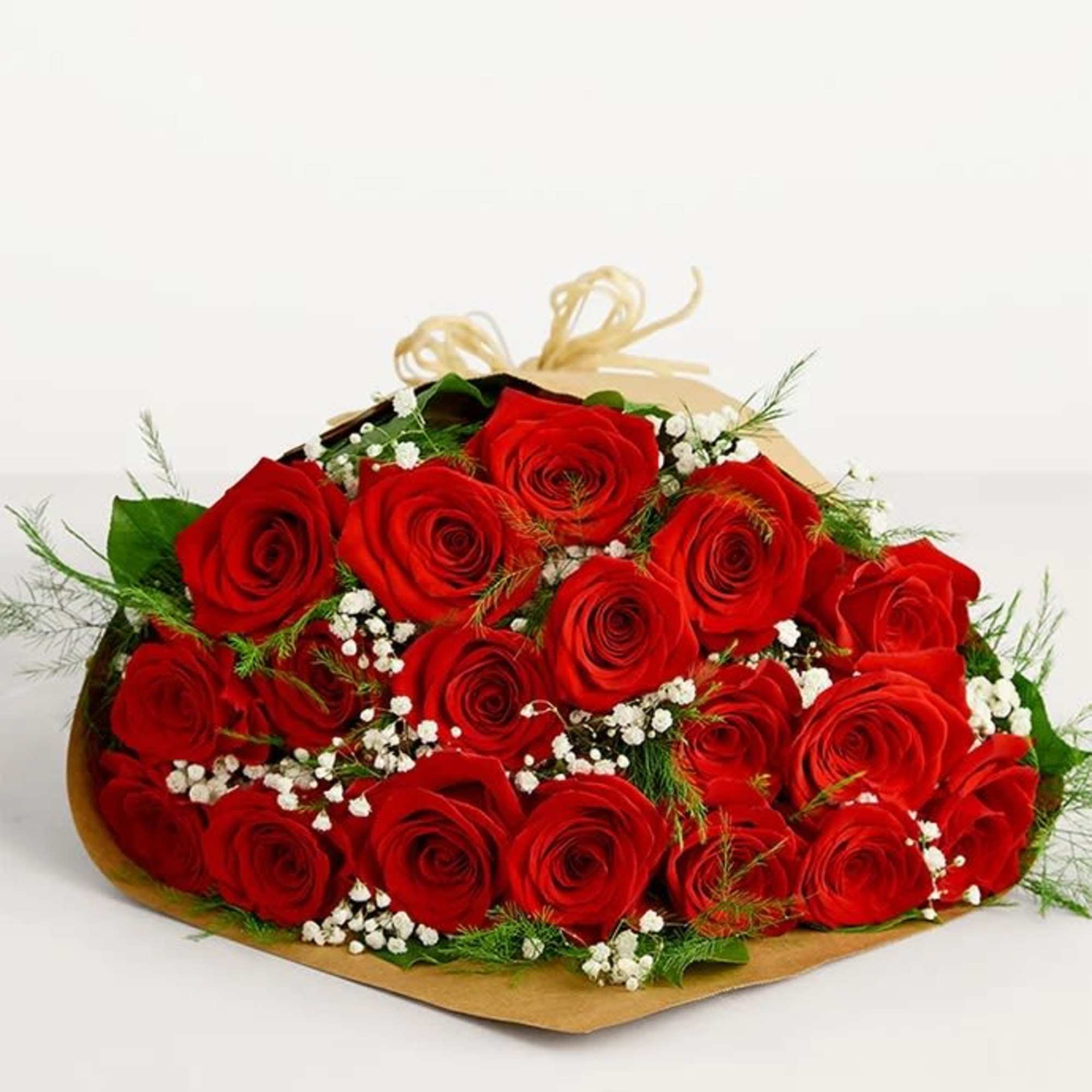 Bouquet of red roses with white filler flowers wrapped in paper