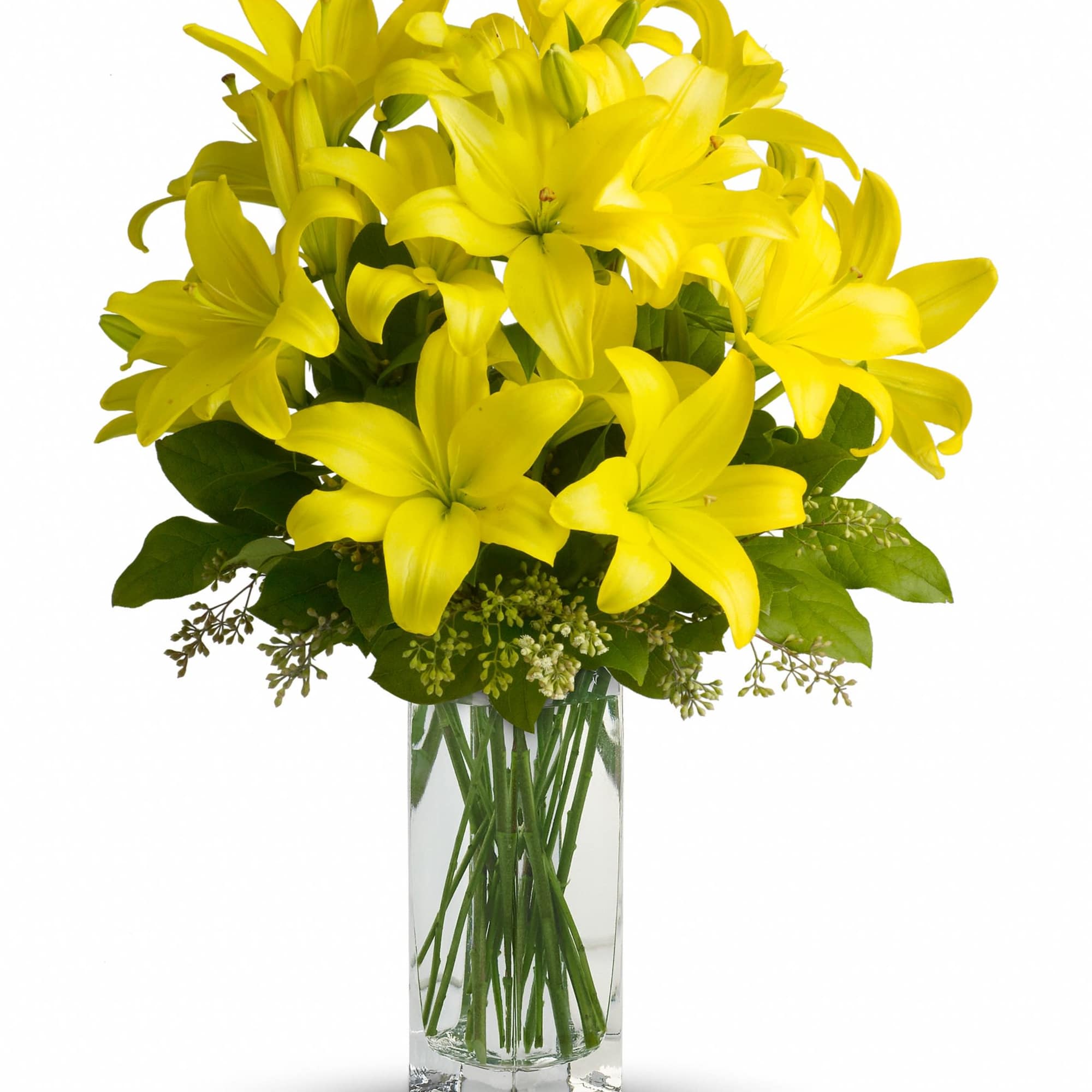 Yellow lilies arranged in a clear glass vase