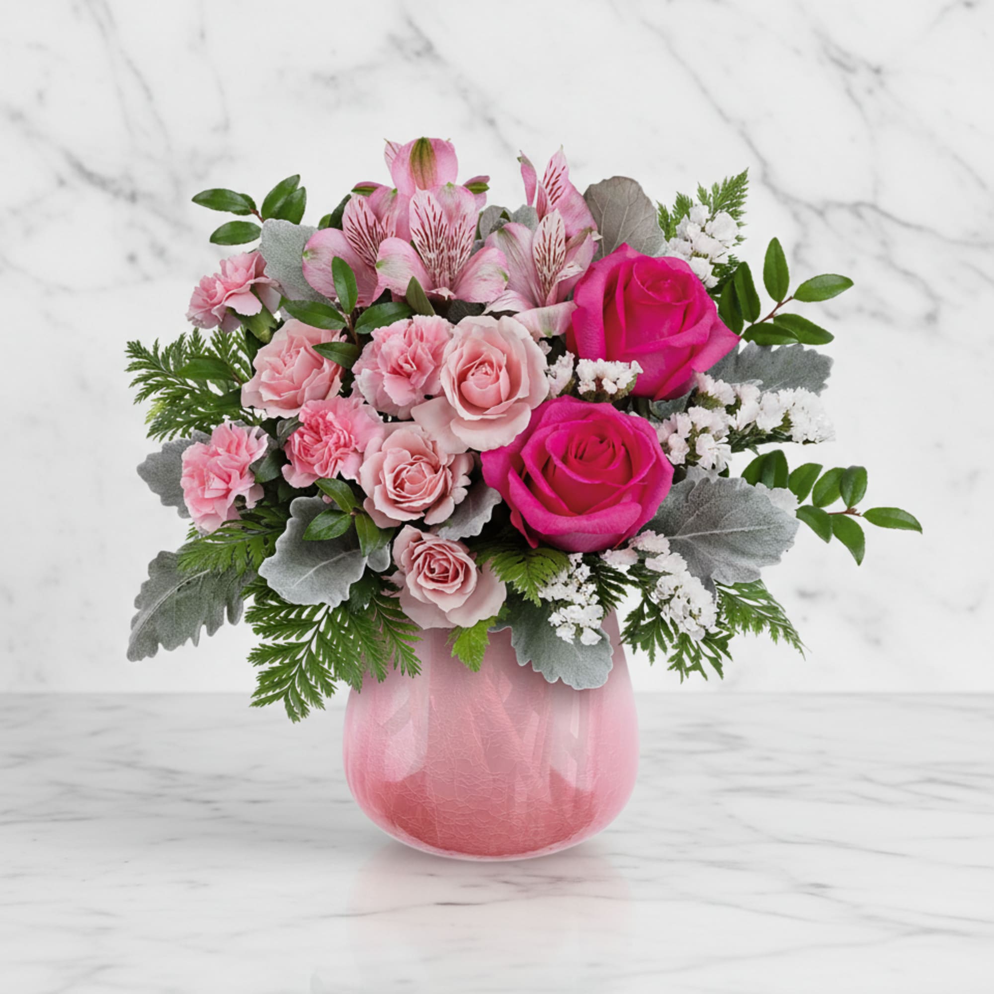 Pink roses and alstroemeria in a pink glass vase