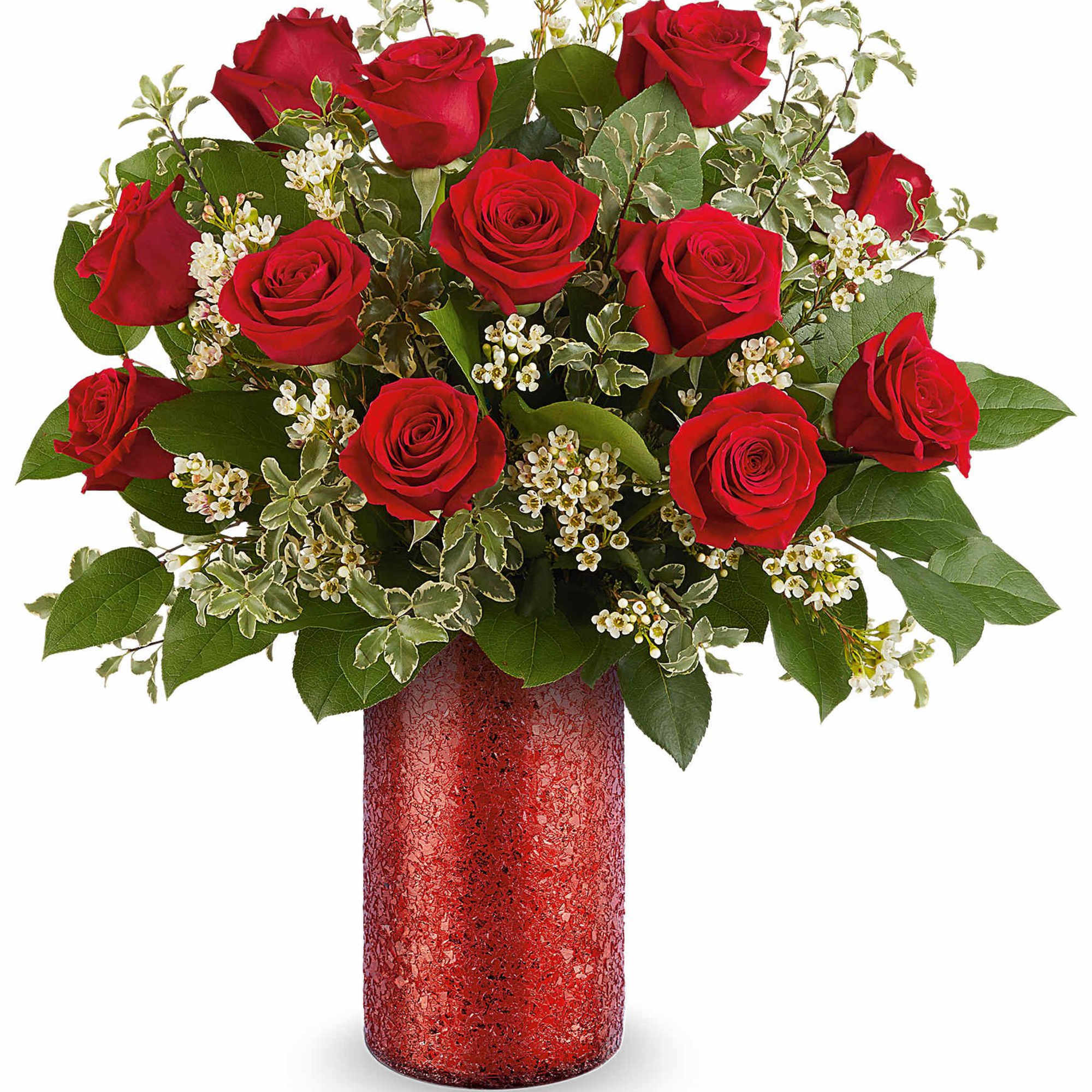 Red roses arranged in a red vase with white filler flowers