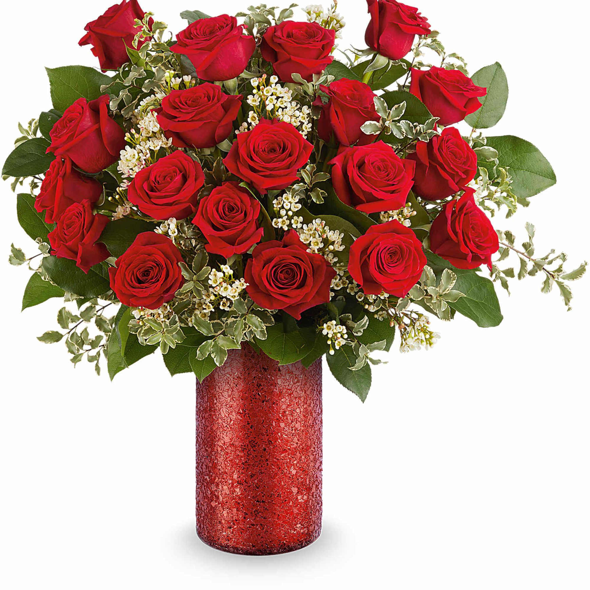 Red roses arranged in a red vase with white filler flowers